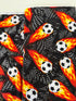 Flaming Soccer Balls Fabric – Goal! by Gail Cadden for Timeless Treasures, black cotton fabric with fiery soccer balls.