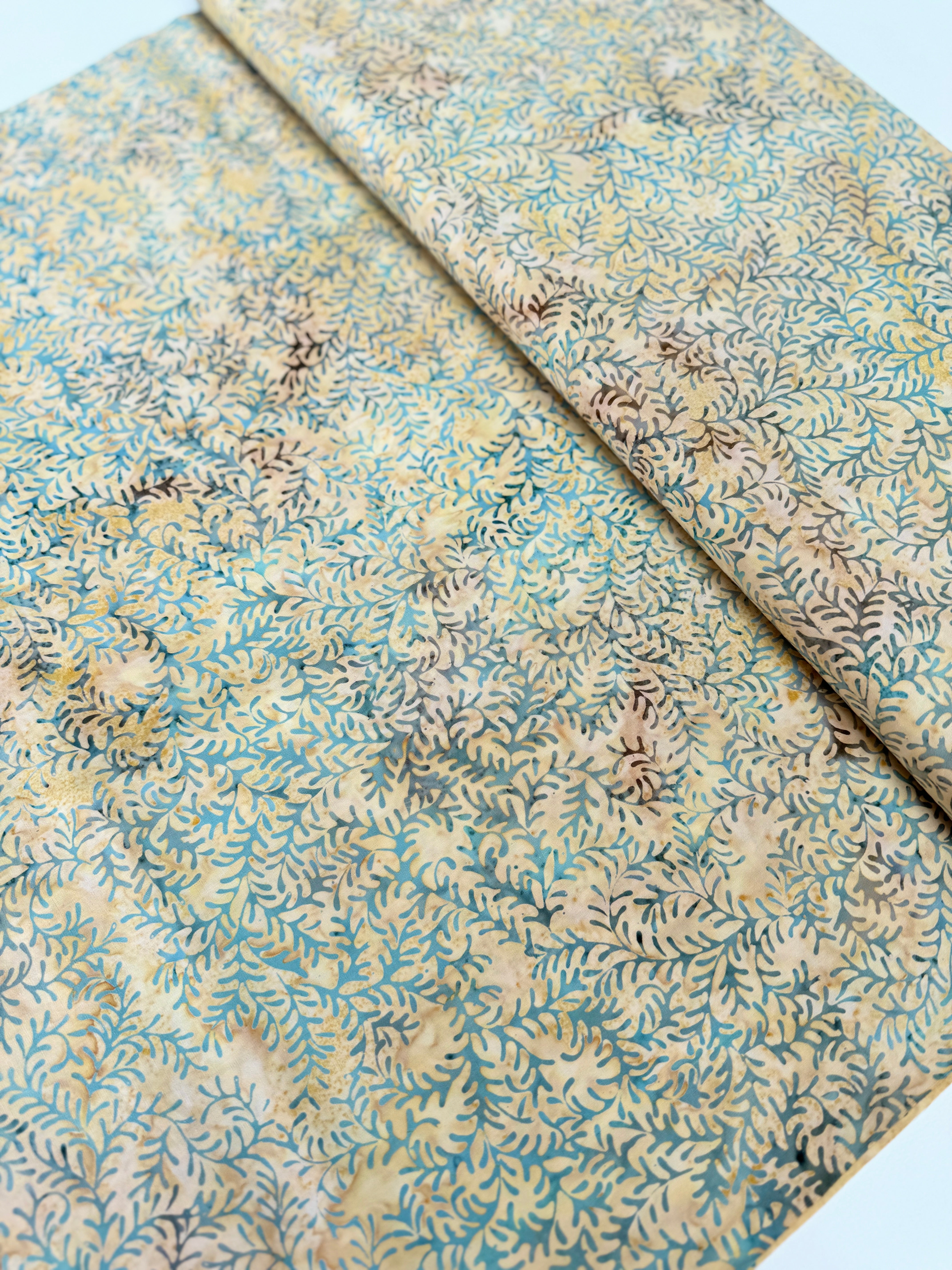 Sea Foam Leaf Vine Batik Fabric by Island Batik – tan and blue hand-dyed cotton with vine print for quilting and crafts.