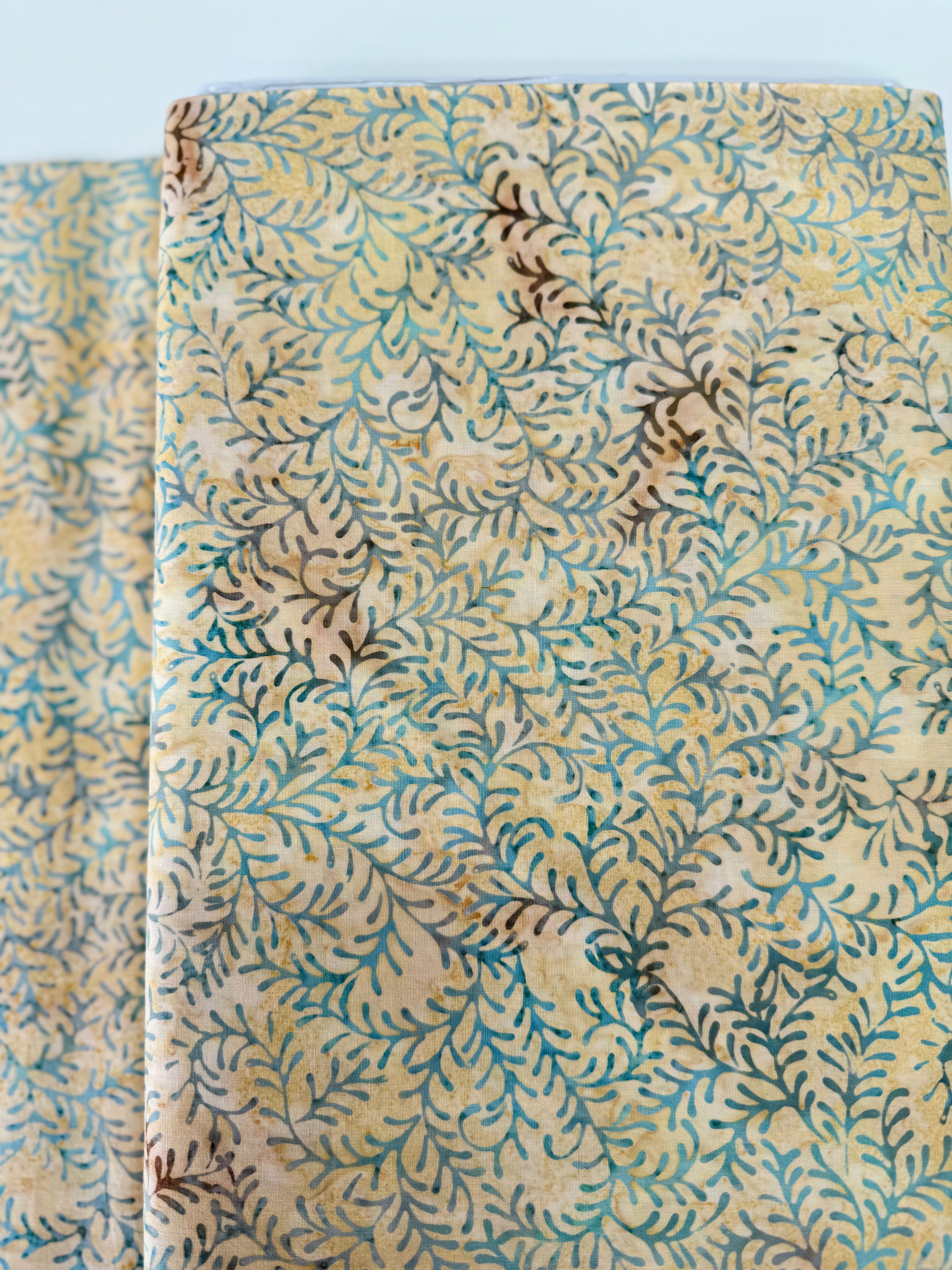 Sea Foam Leaf Vine Batik Fabric by Island Batik – tan and blue hand-dyed cotton with vine print for quilting and crafts.