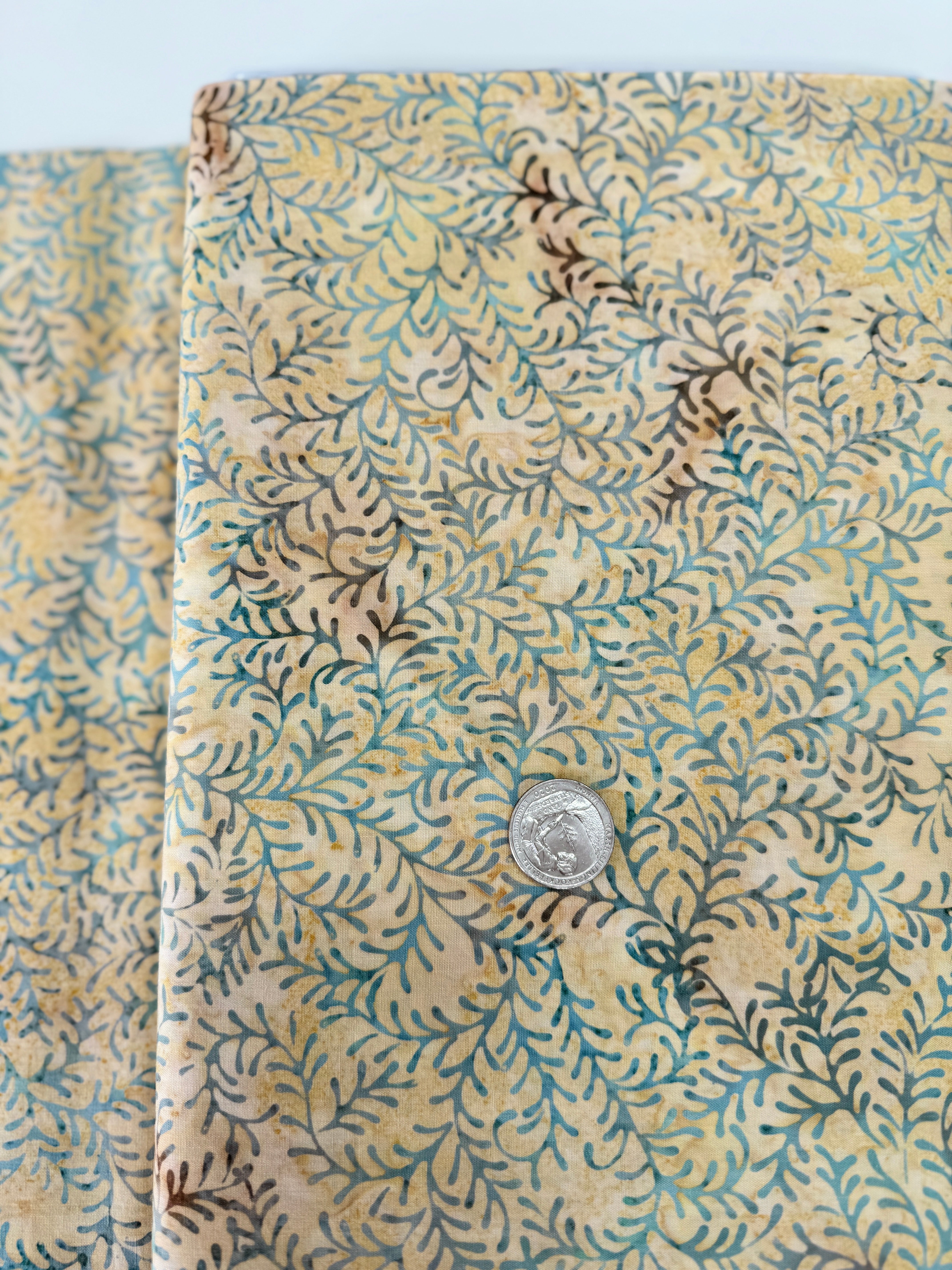 Sea Foam Leaf Vine Batik Fabric by Island Batik – tan and blue hand-dyed cotton with vine print for quilting and crafts.