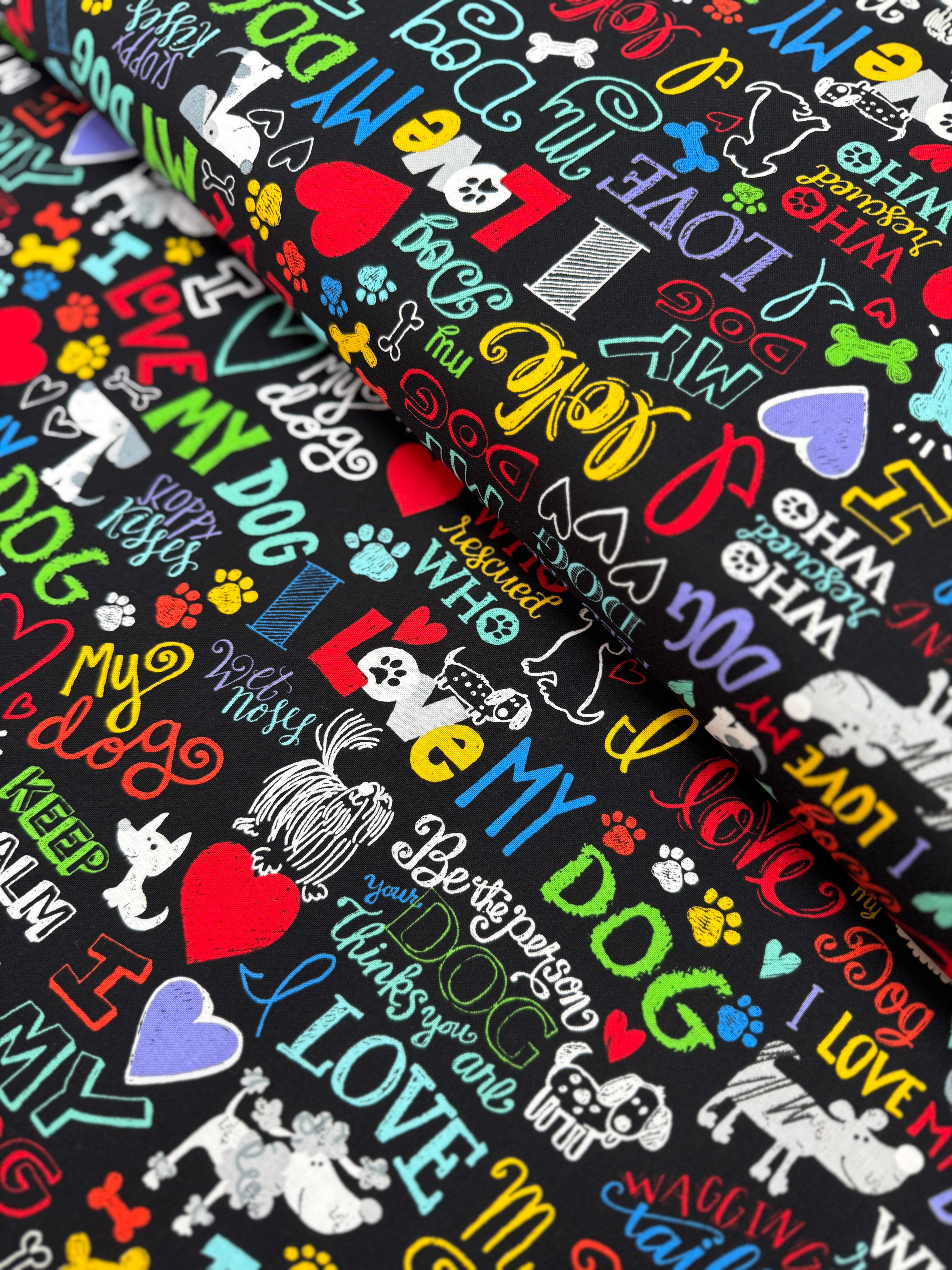 I Love My Dog Black fabric by Gail Cadden for Timeless Treasures – colorful dog-themed words on black cotton.