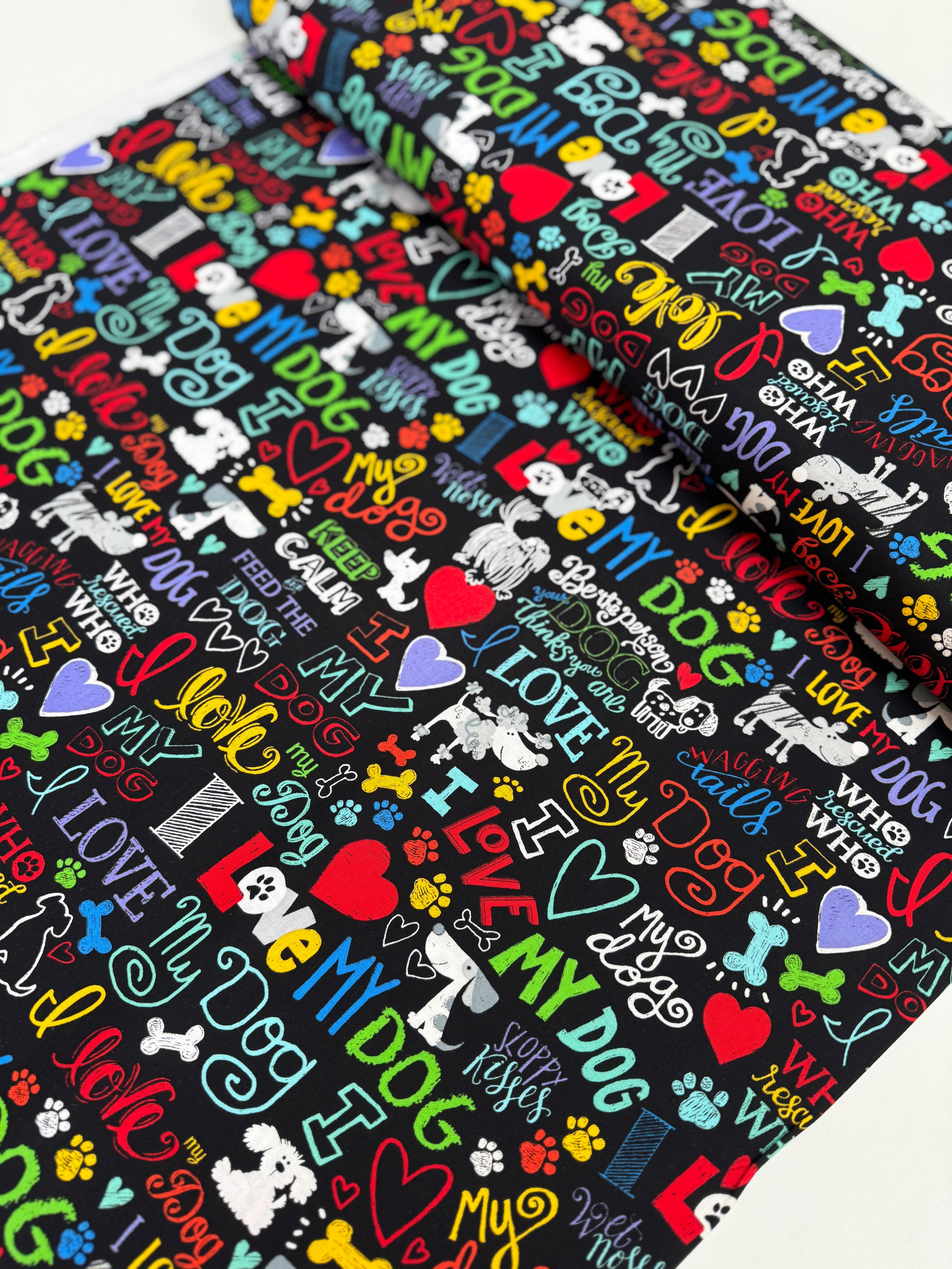 I Love My Dog Black fabric by Gail Cadden for Timeless Treasures – colorful dog-themed words on black cotton.
