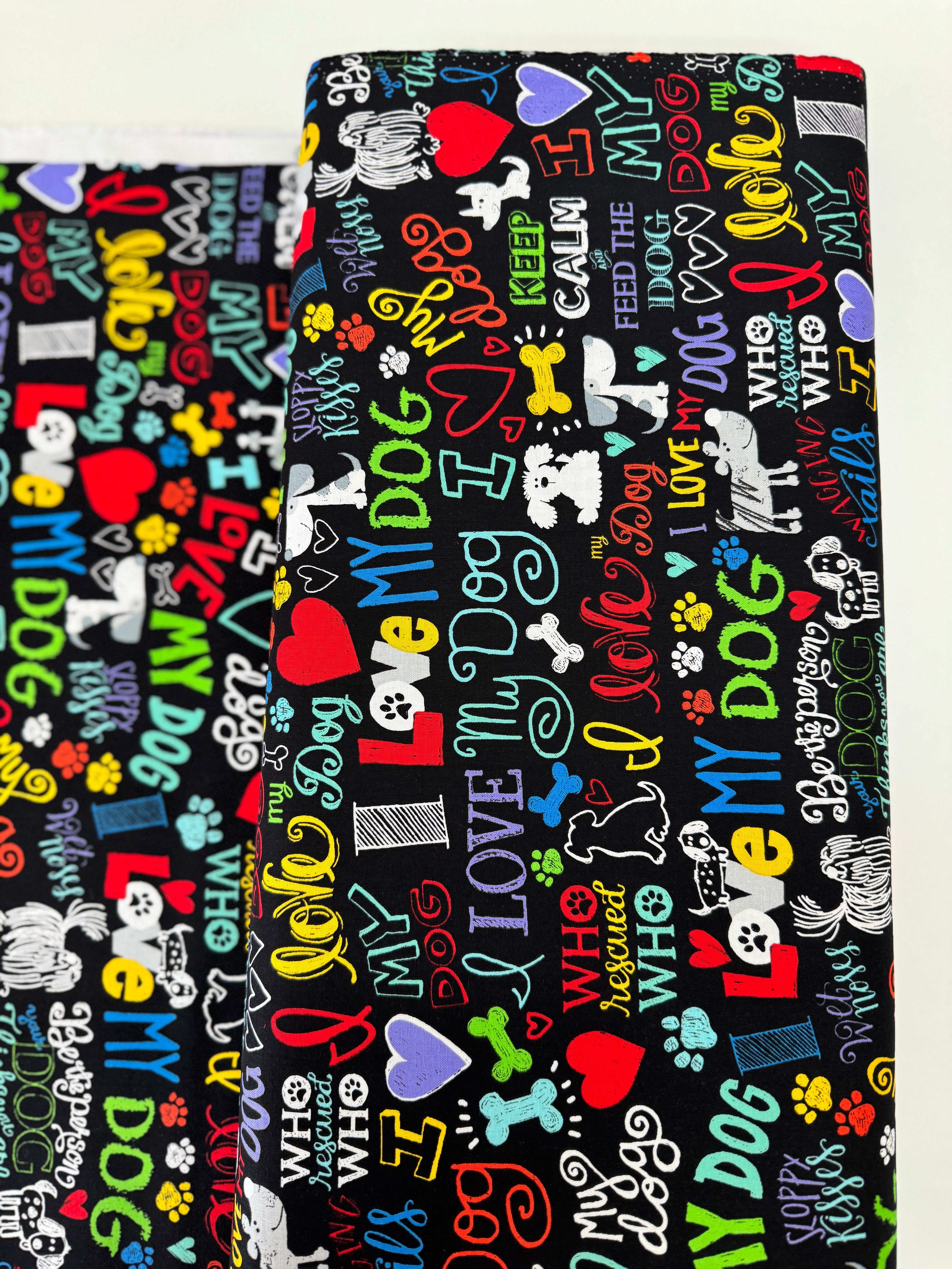 I Love My Dog Black fabric by Gail Cadden for Timeless Treasures – colorful dog-themed words on black cotton.
