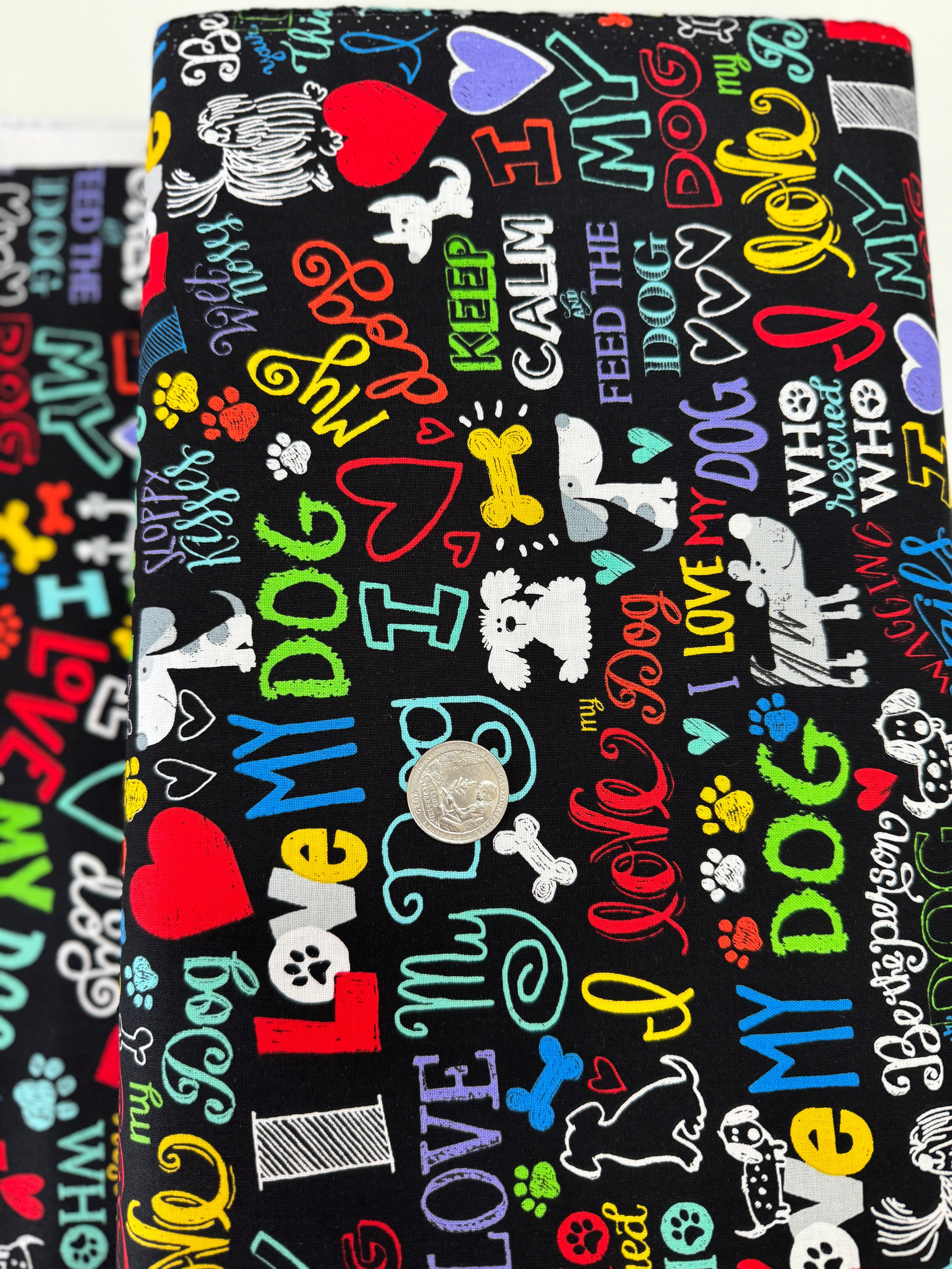 I Love My Dog Black fabric by Gail Cadden for Timeless Treasures – colorful dog-themed words on black cotton.