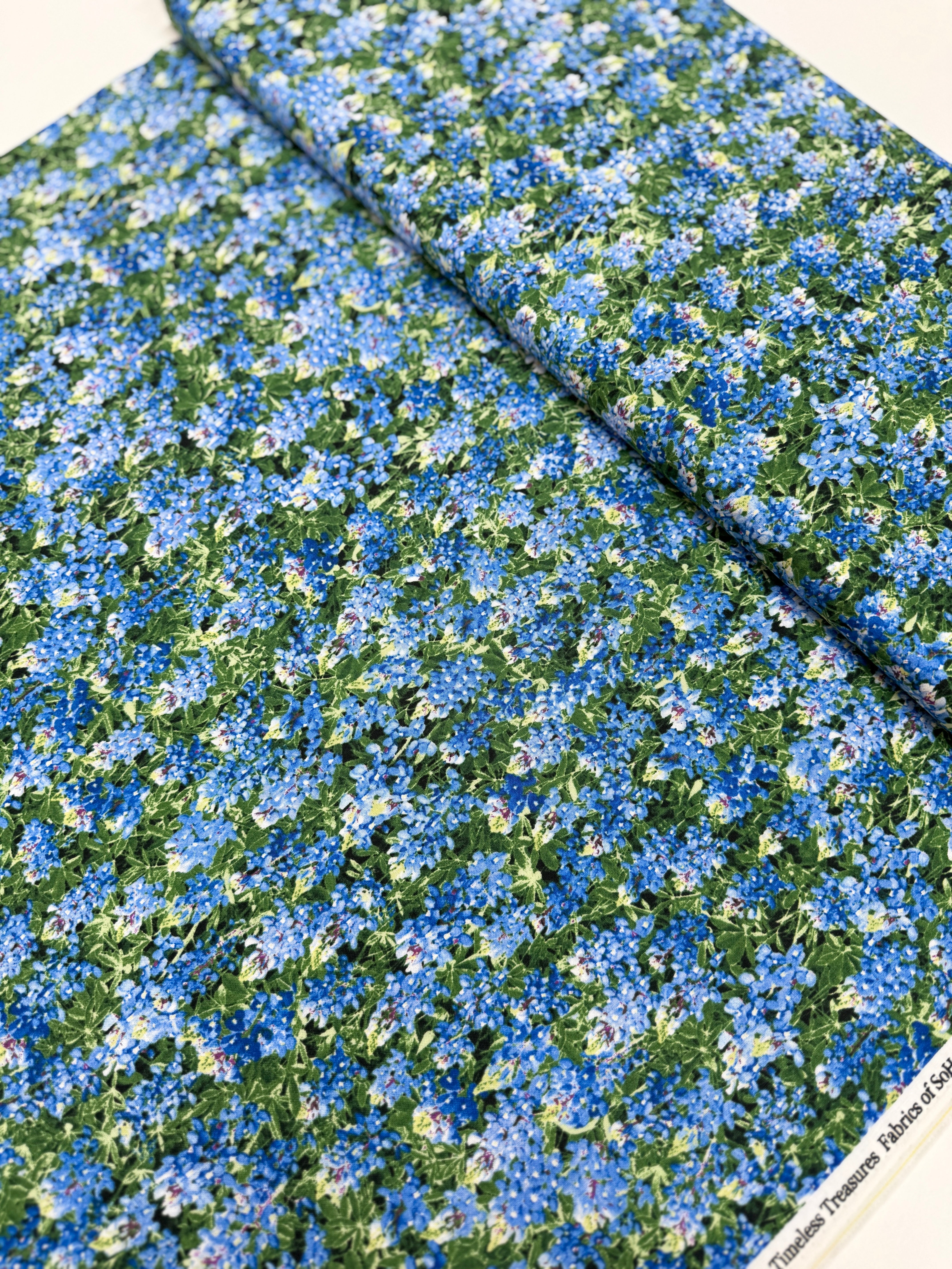 Spring Beauty – Packed Blue Bonnets Fabric by Timeless Treasures – 100% cotton wildflower print in blue and green.