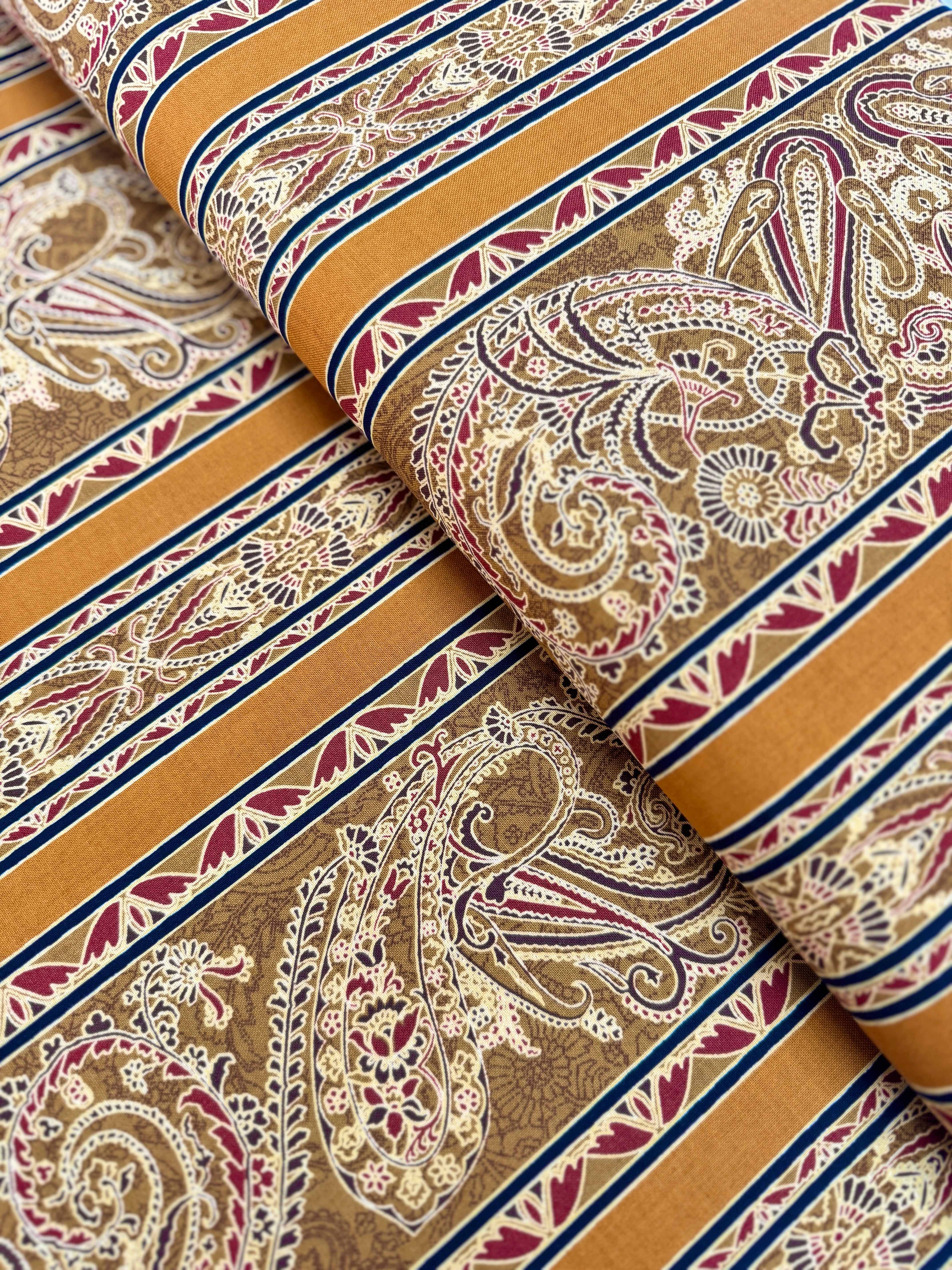Delhi - Border Golden fabric by Jinny Beyer for RJR Fabrics with ornate Indian-style border design in rich golden tones on 100% cotton.