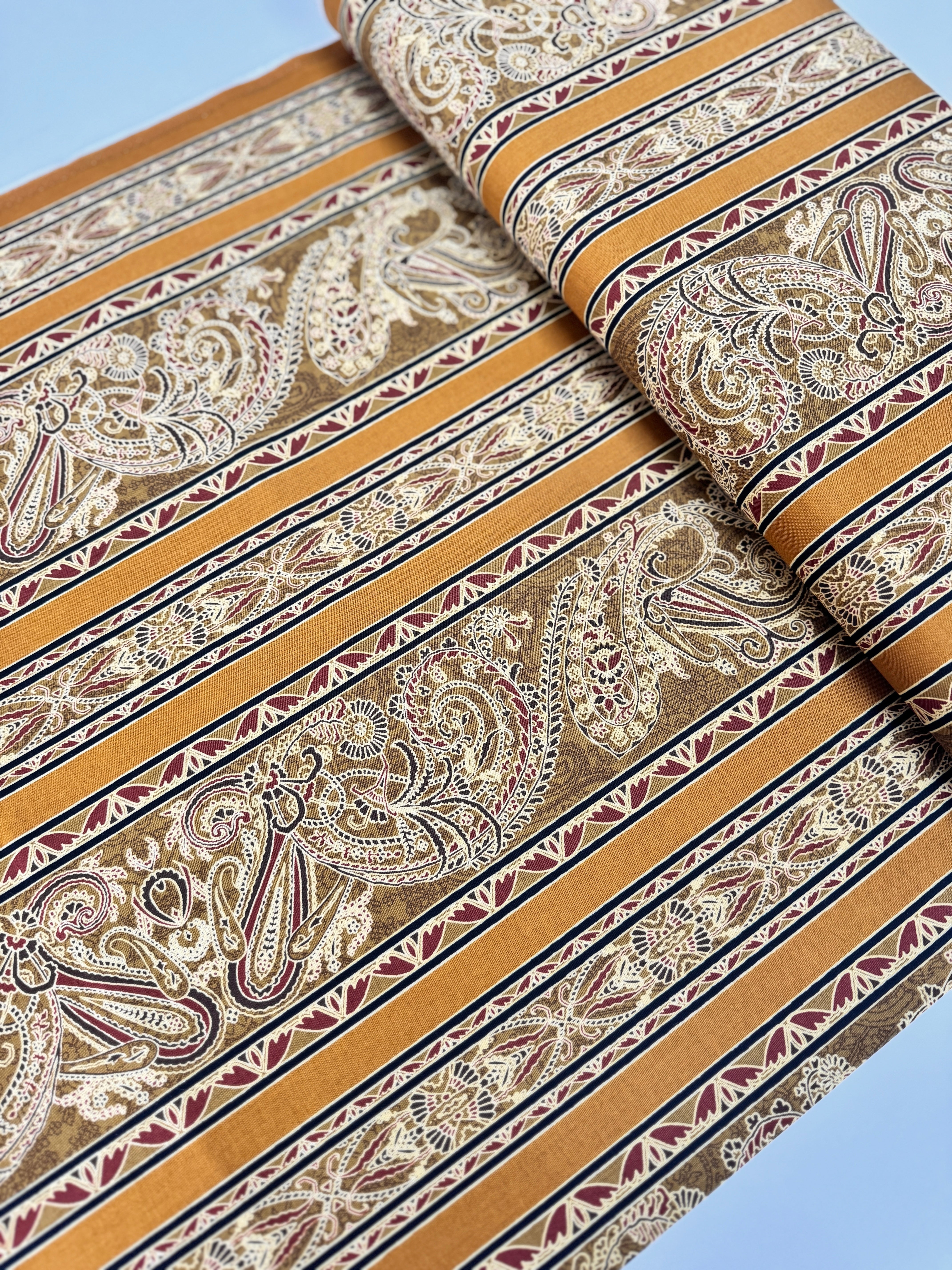 Delhi - Border Golden fabric by Jinny Beyer for RJR Fabrics with ornate Indian-style border design in rich golden tones on 100% cotton.