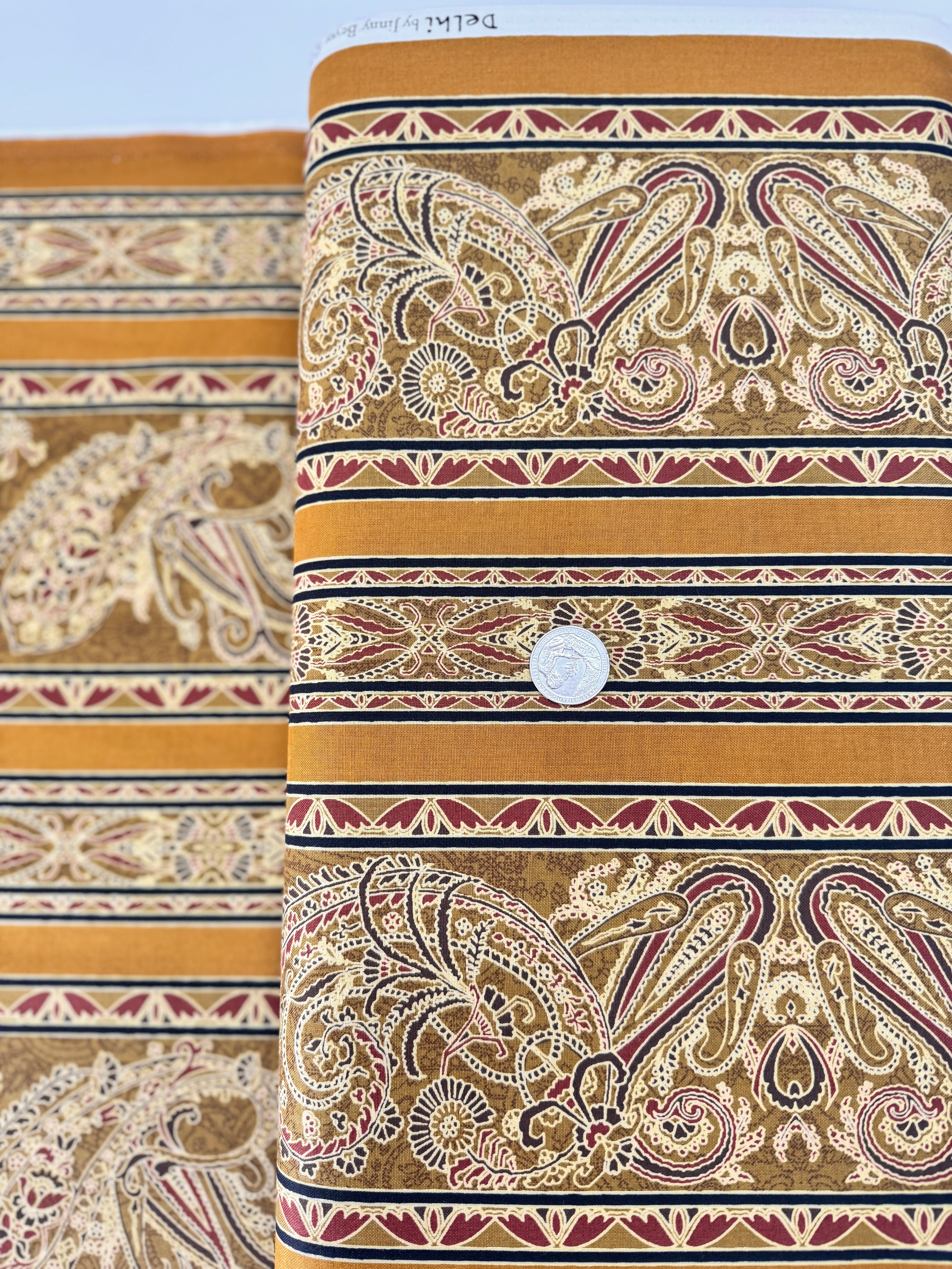 Delhi - Border Golden fabric by Jinny Beyer for RJR Fabrics with ornate Indian-style border design in rich golden tones on 100% cotton.