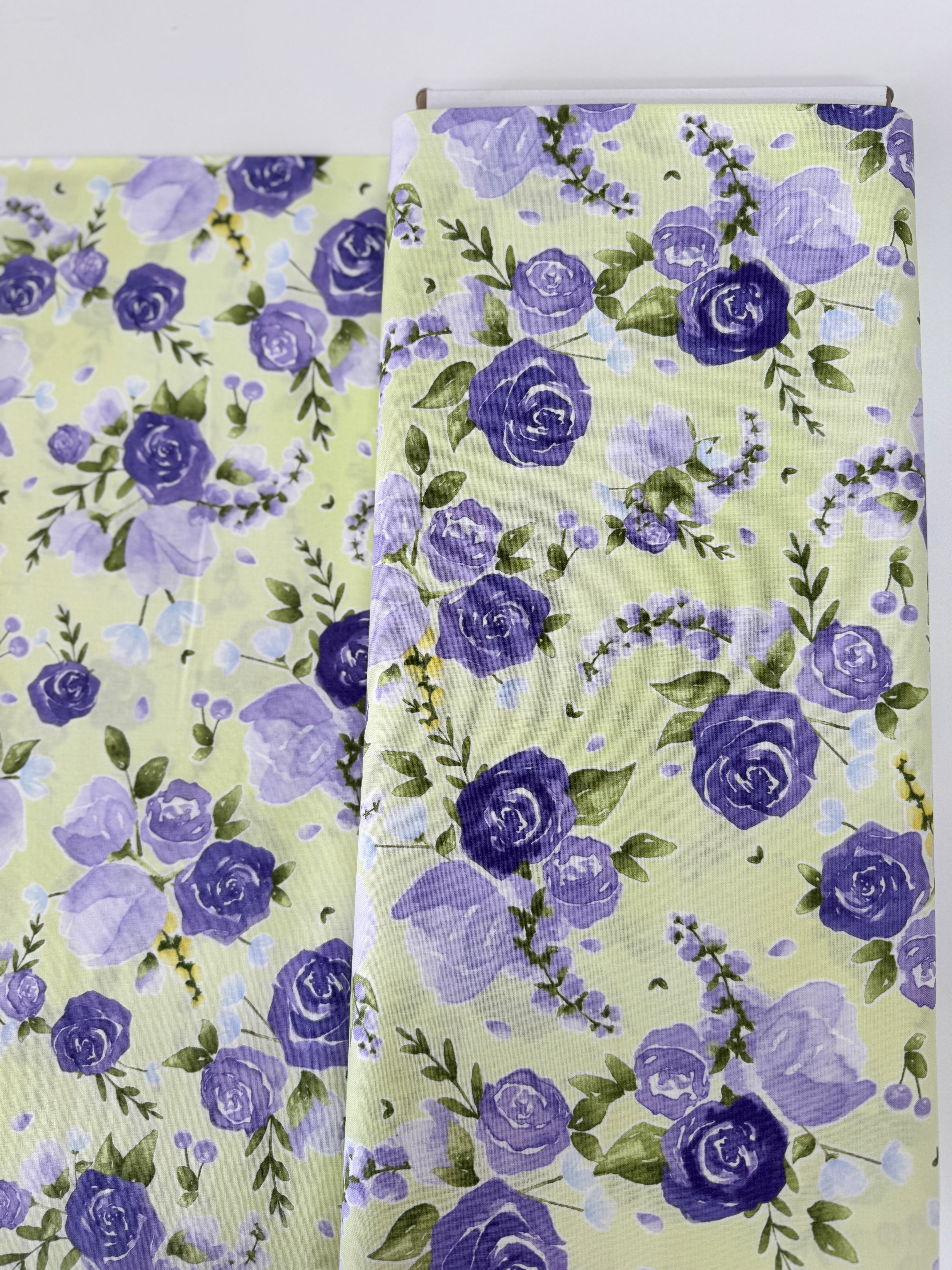 June’s Cottage Prized Roses Meadow cotton fabric by Briar Hill Designs for RJR Fabrics – rose blossoms in purple and lavender on soft background, 43"/44" wide