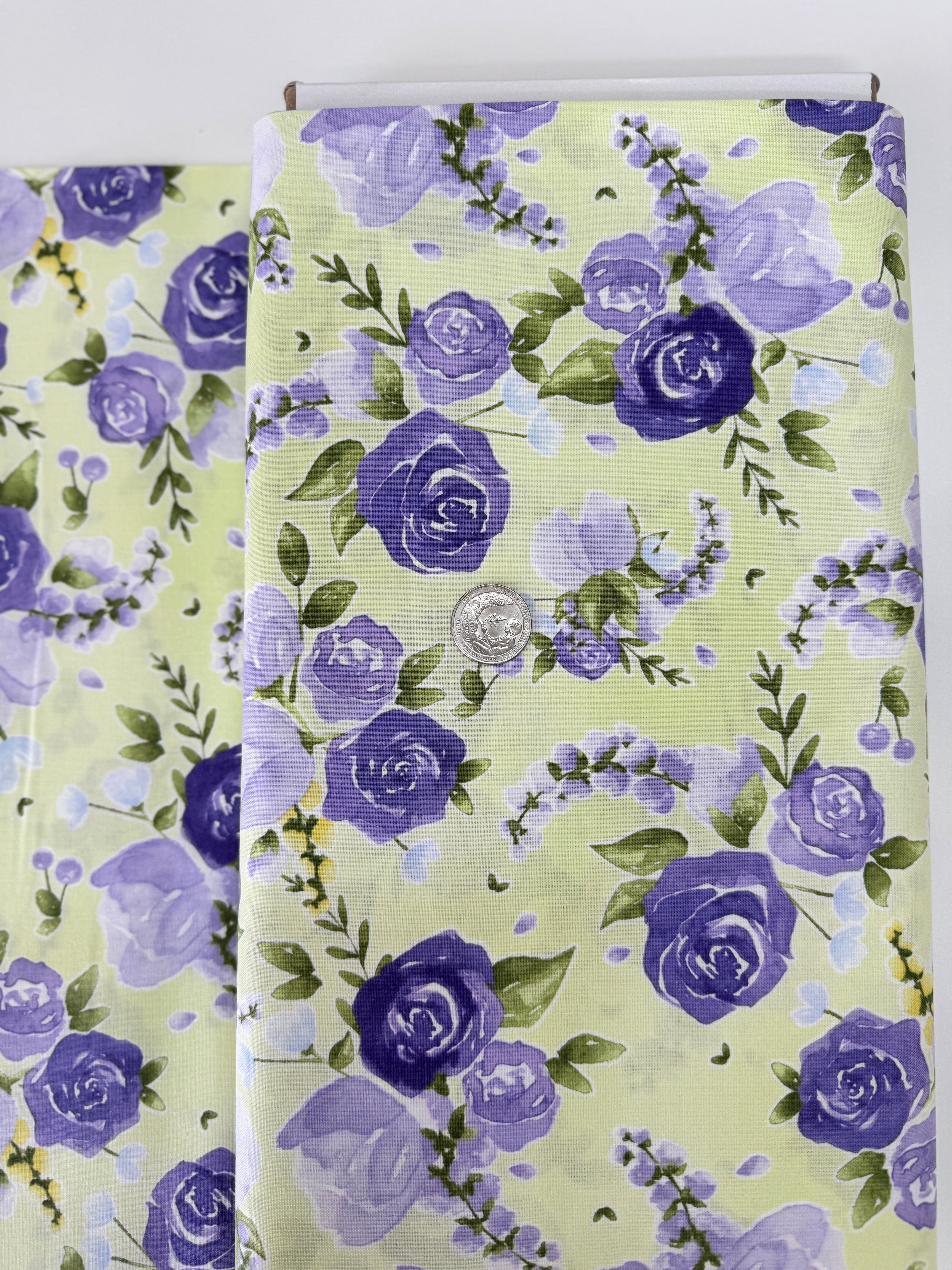 June’s Cottage Prized Roses Meadow cotton fabric by Briar Hill Designs for RJR Fabrics – rose blossoms in purple and lavender on soft background, 43"/44" wide