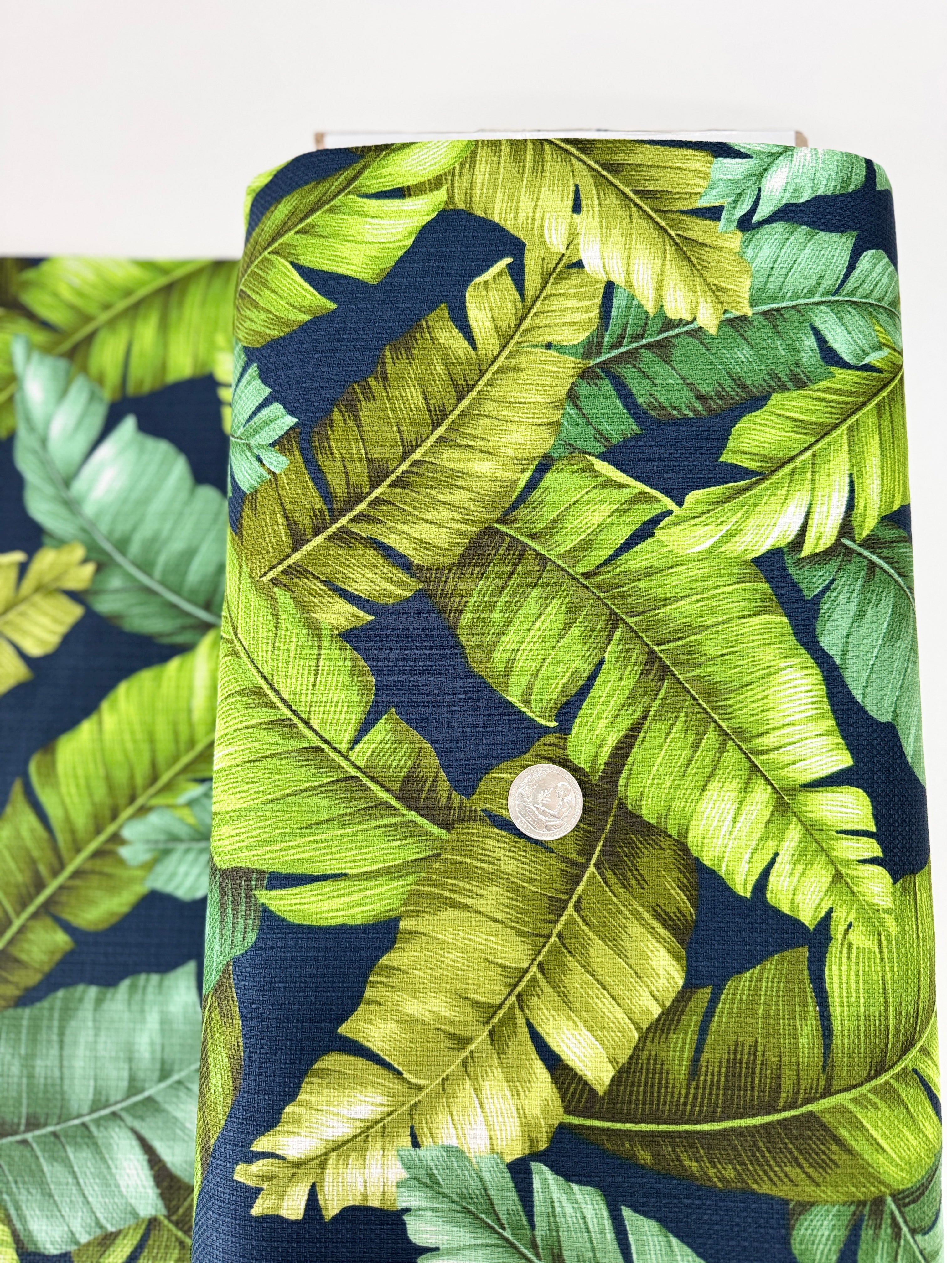 Sevenberry Island Paradise barkcloth fabric by Sevenberry for Robert Kaufman – navy background with tropical leaves; 90% cotton barkcloth