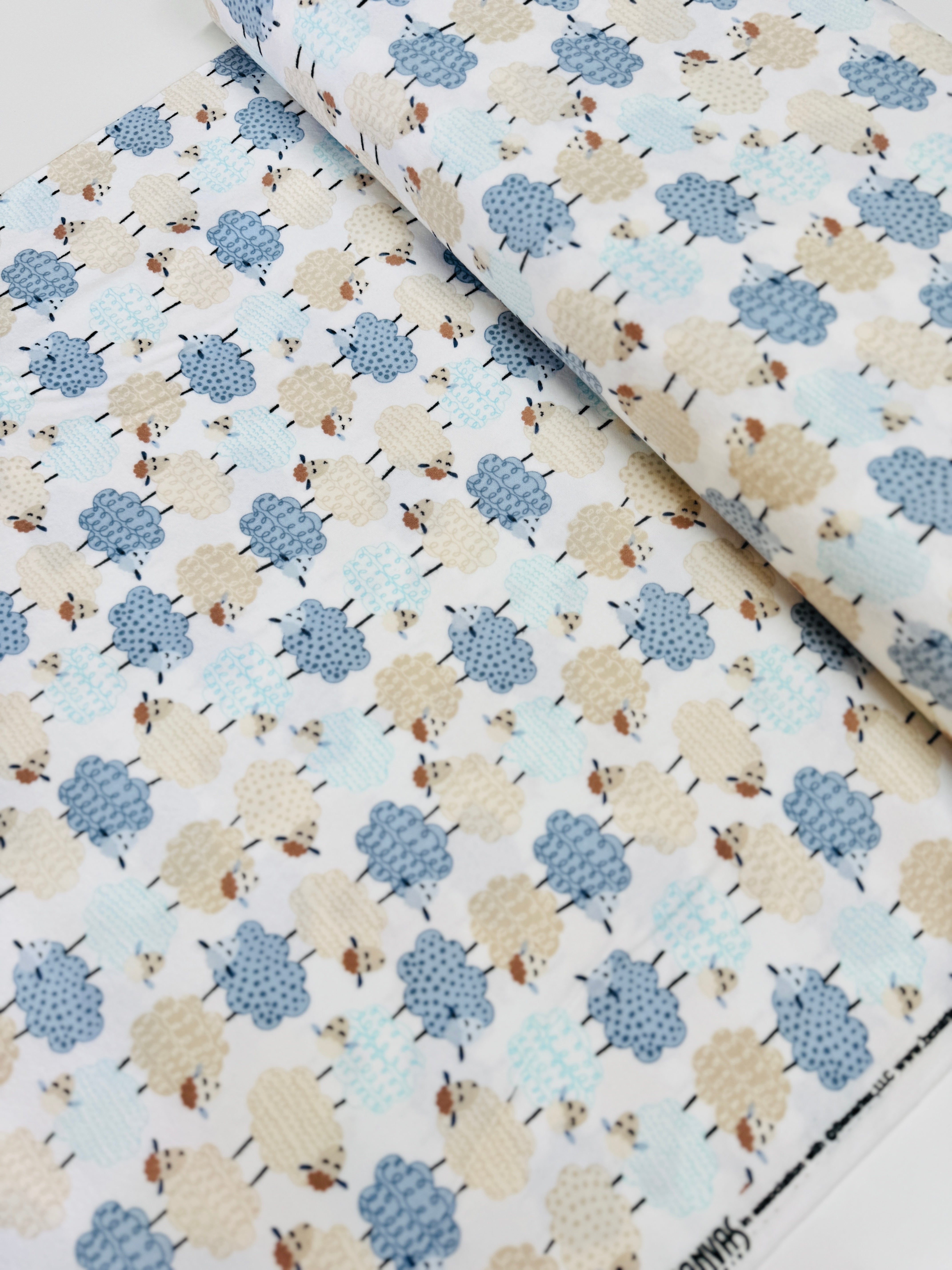 Sweet Dreams Flannel – White fabric with playful stacked sheep design by Kanvas Studio for Benartex, soft brushed cotton flannel.