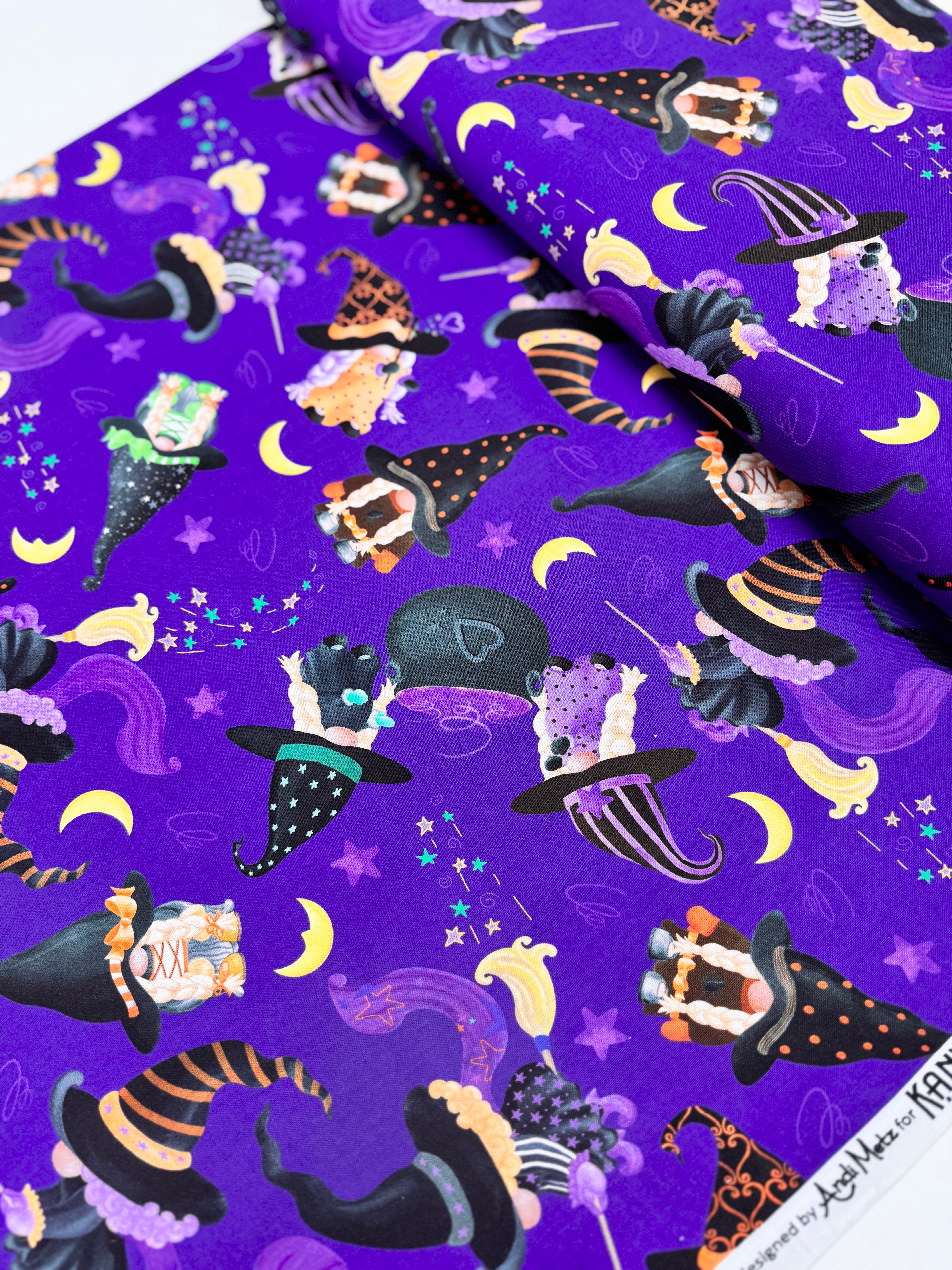 Spooktacular Gnomes fabric with purple background, Halloween gnomes, pumpkins, and stars – 12796-66 by Andi Metz for Kanvas Studio.