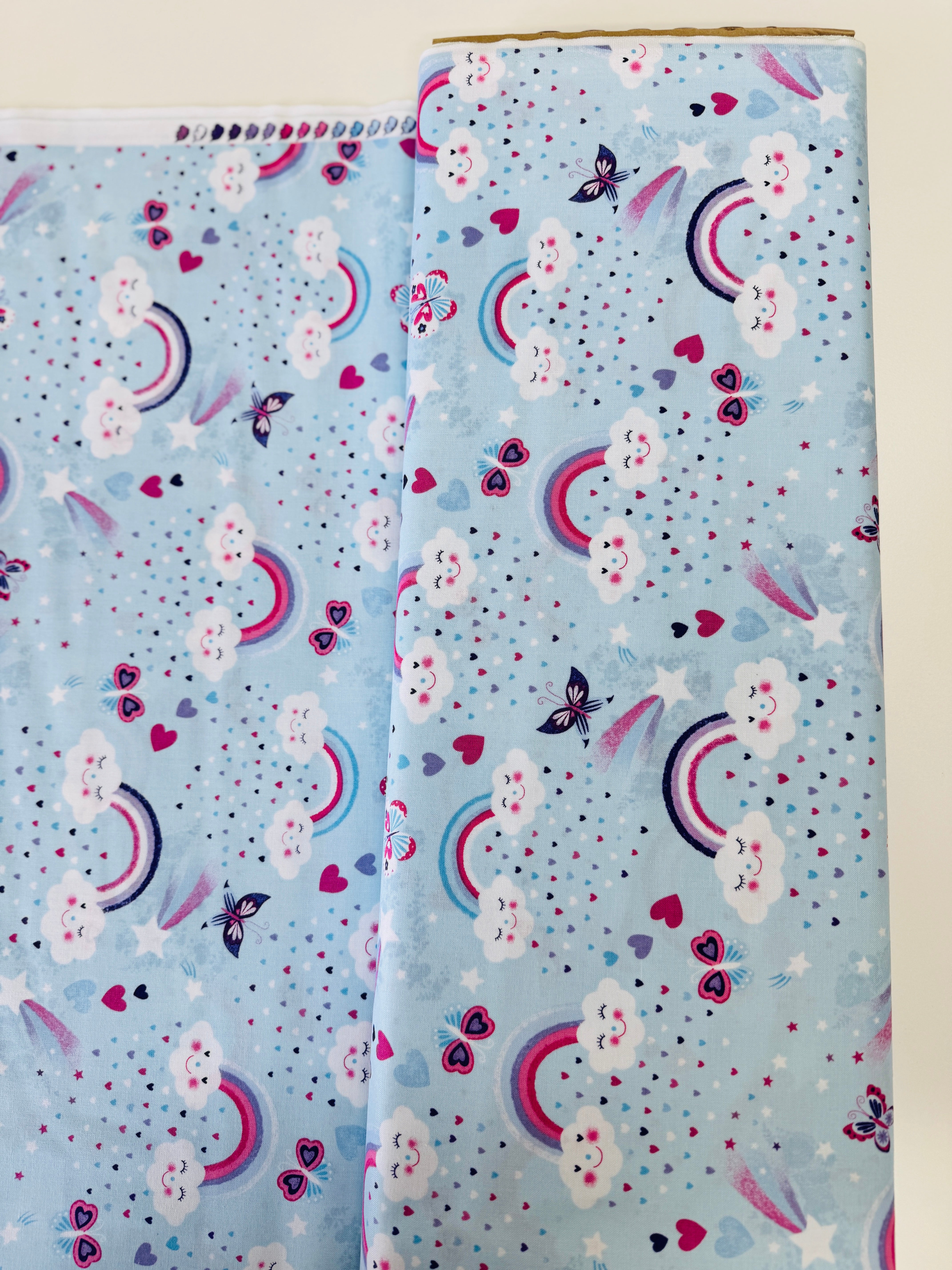 Unicorn Kisses Rainbow and Clouds cotton fabric by Studio E – cheerful rainbow and fluffy cloud motif on quilting cotton, 43″ wide