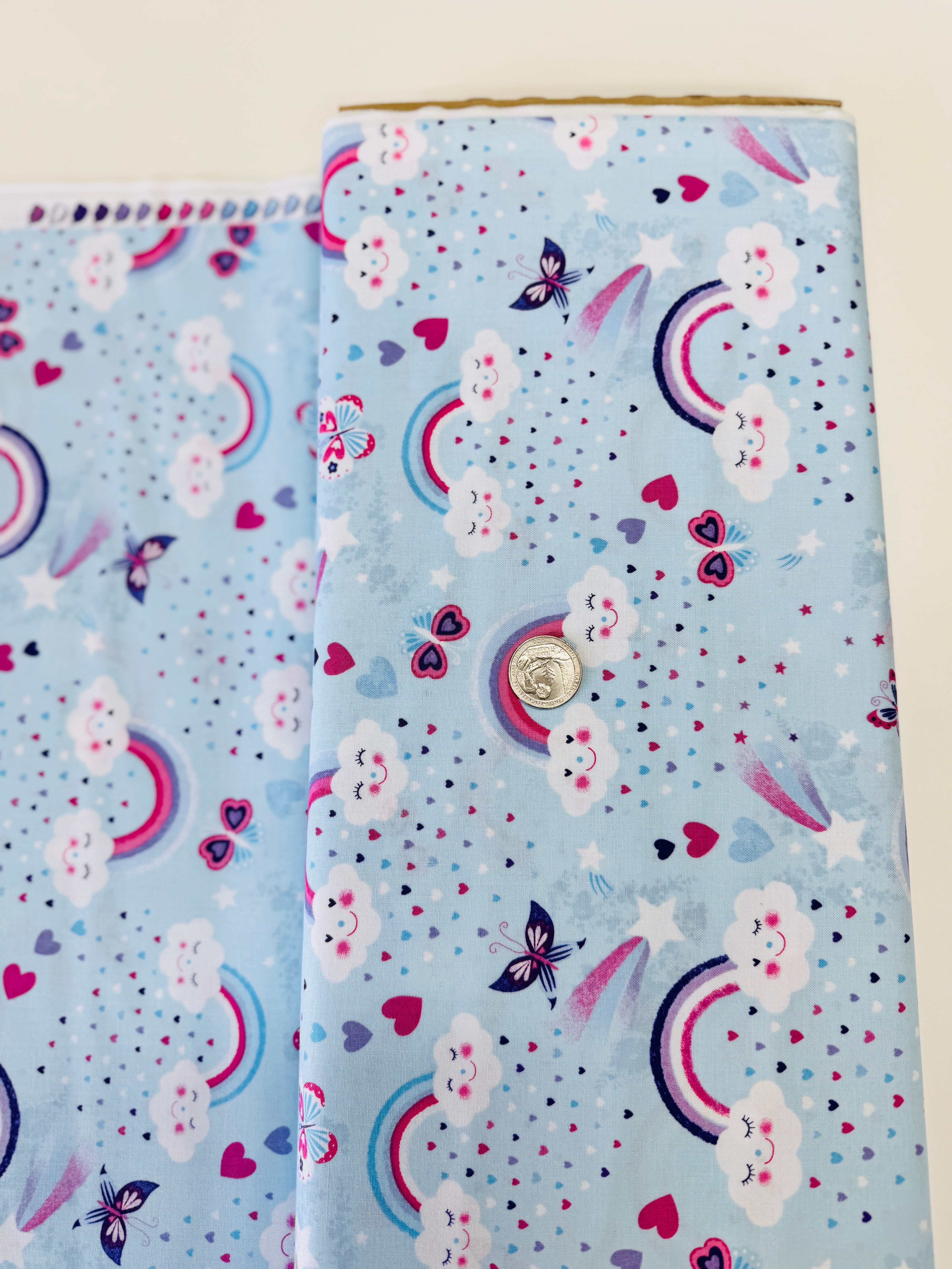 Unicorn Kisses Rainbow and Clouds cotton fabric by Studio E – cheerful rainbow and fluffy cloud motif on quilting cotton, 43″ wide