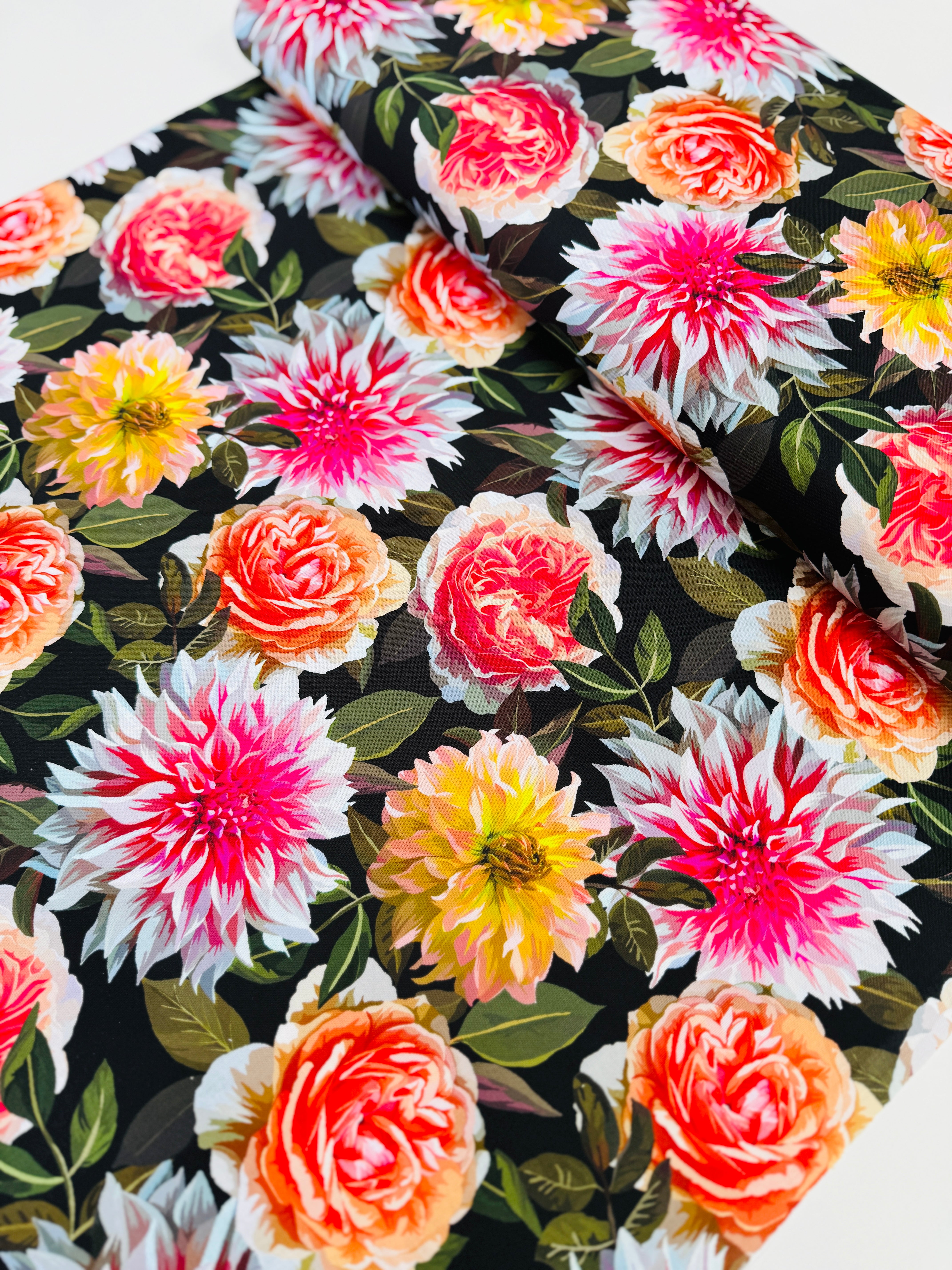 Enchanted Field Dreaming of Dahlias Pink Glow quilting cotton by RJR Studio – vibrant pink and peach dahlias on black background, 43–44″ wide