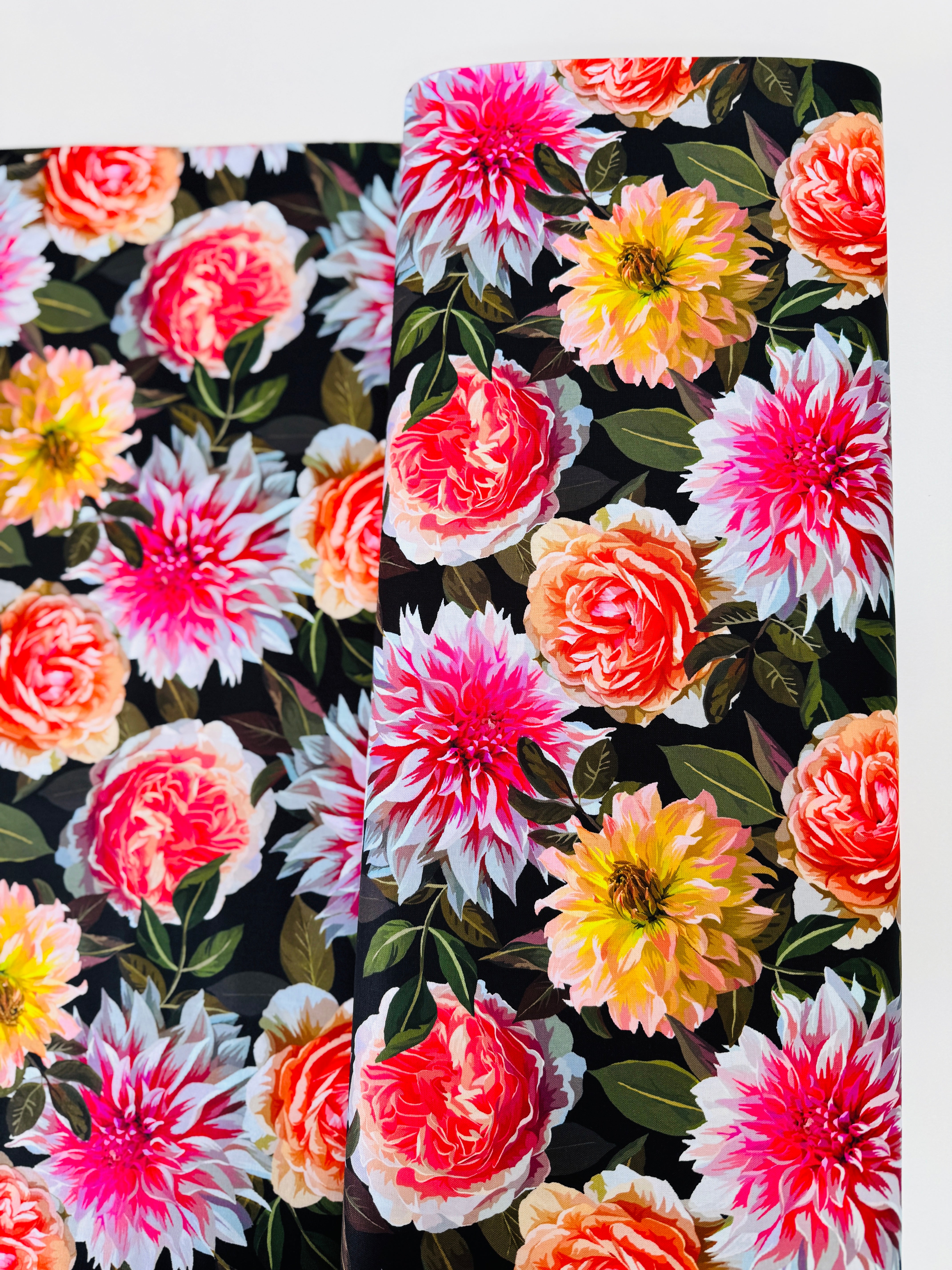 Enchanted Field Dreaming of Dahlias Pink Glow quilting cotton by RJR Studio – vibrant pink and peach dahlias on black background, 43–44″ wide