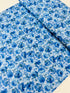Garden Blues Sky quilting cotton by Sevenberry for Robert Kaufman – delicate blue blossoms on light sky‑blue background, 43–44″ wide