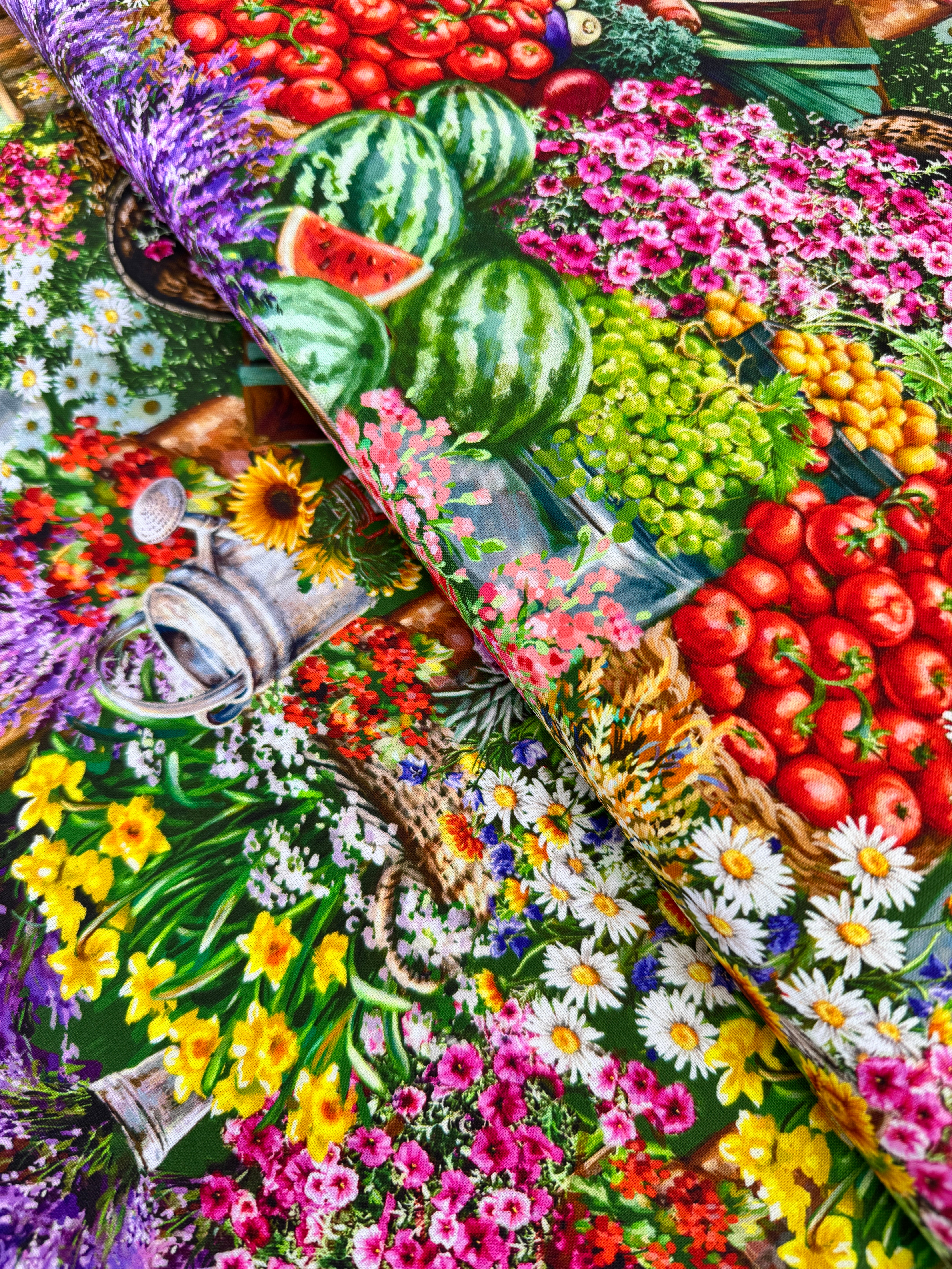 Farm Stand quilting cotton by Dona Gelsinger for Timeless Treasures – colorful produce, flowers, and garden tools on a green background, 43/44″ wide