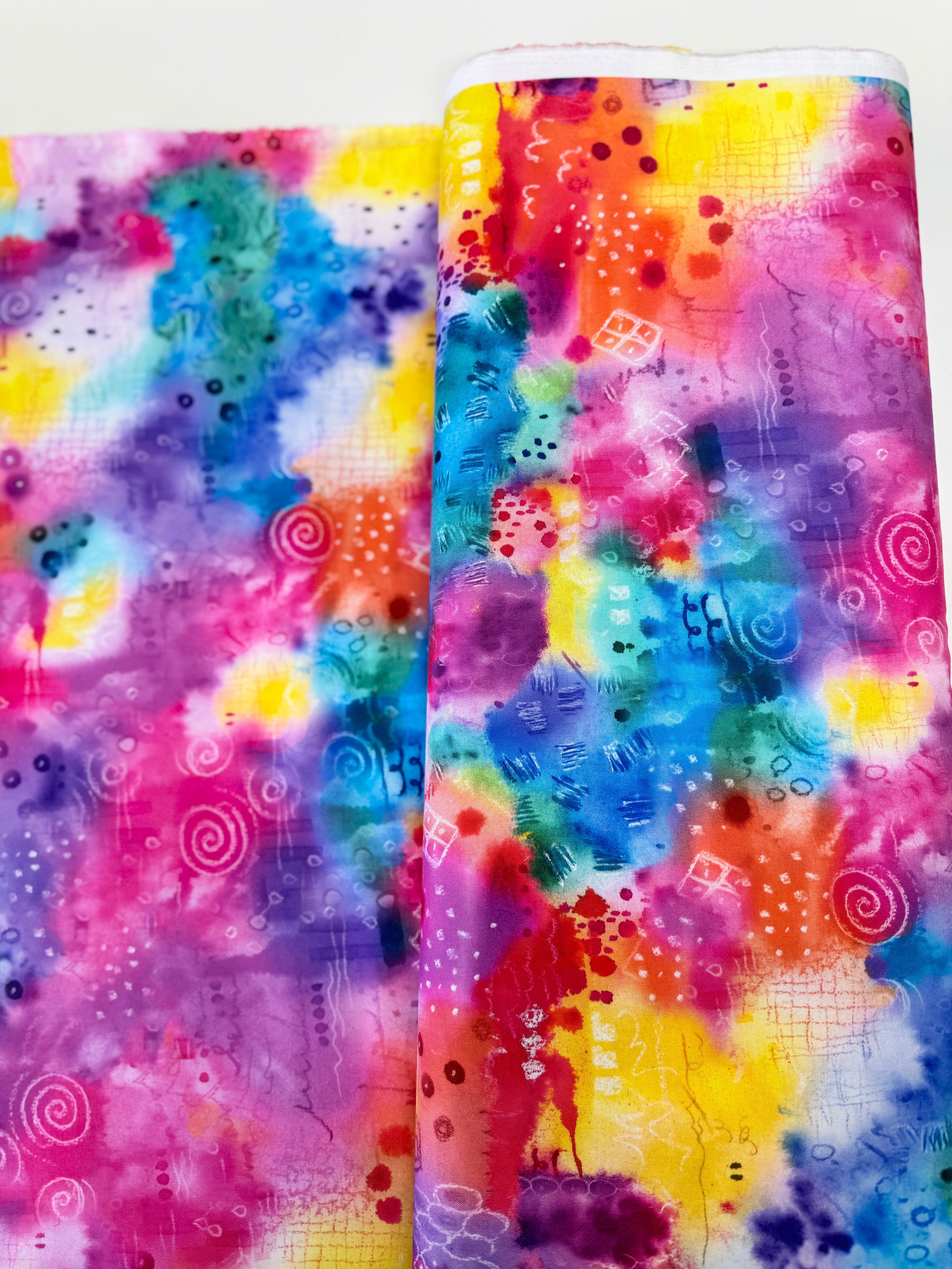Good Vibes rainbow fabric by Hoffman Fabrics with vibrant digital spectrum design on cotton.