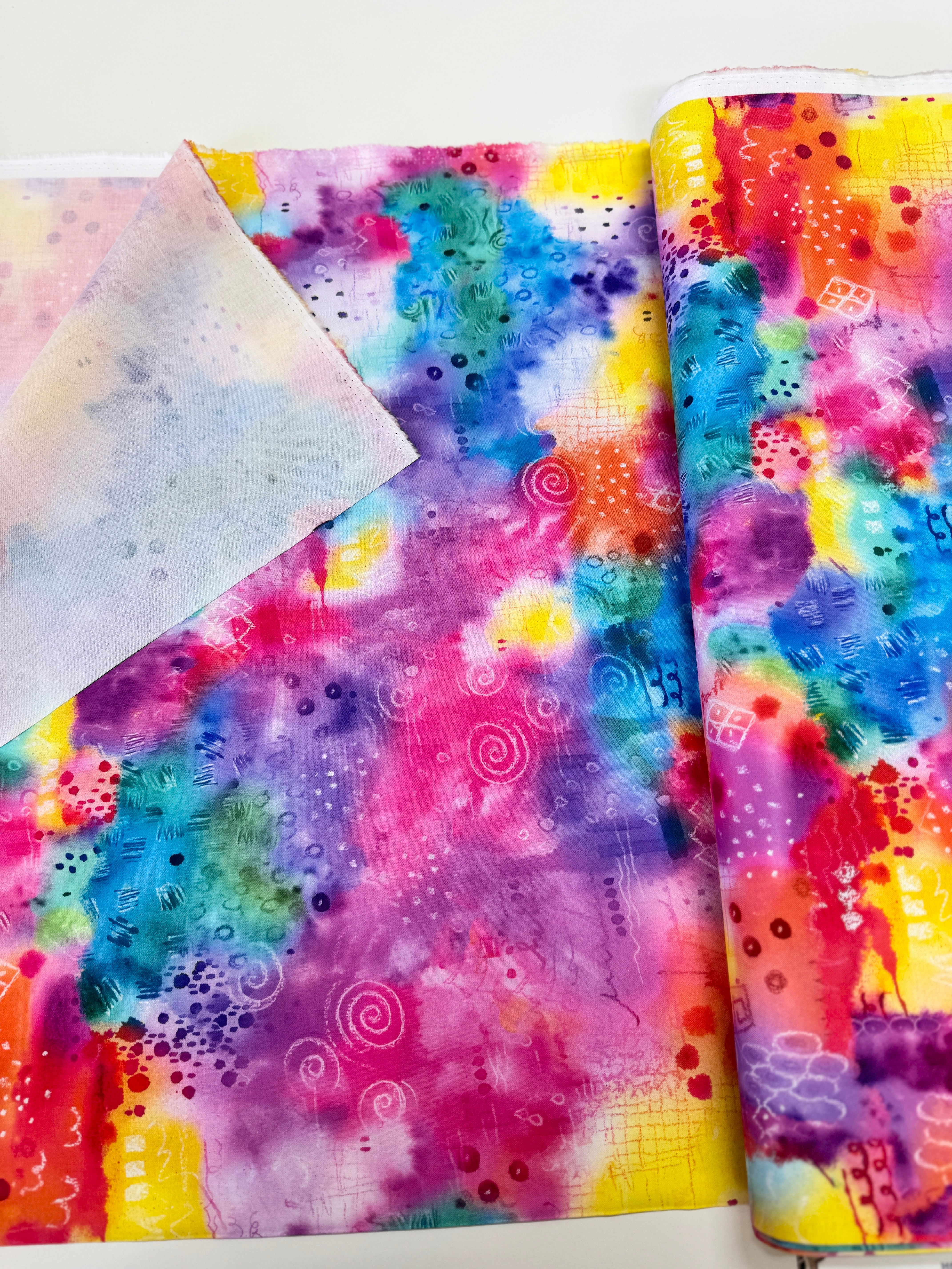 Good Vibes rainbow fabric by Hoffman Fabrics with vibrant digital spectrum design on cotton.