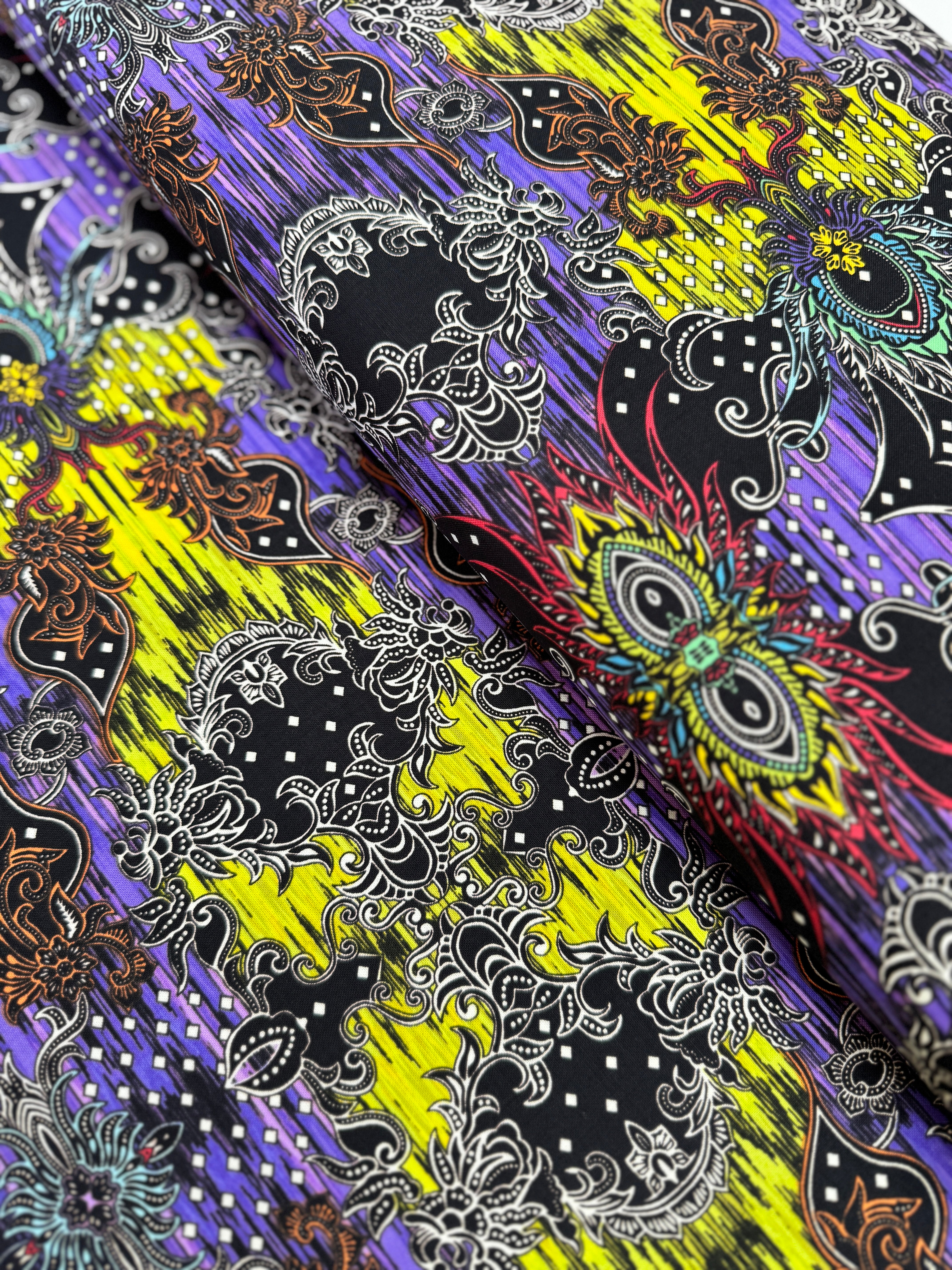 Close-up of Where in the World – Bali Green/Multi fabric by Paula Nadelstern for Benartex, digitally printed with intricate medallions.