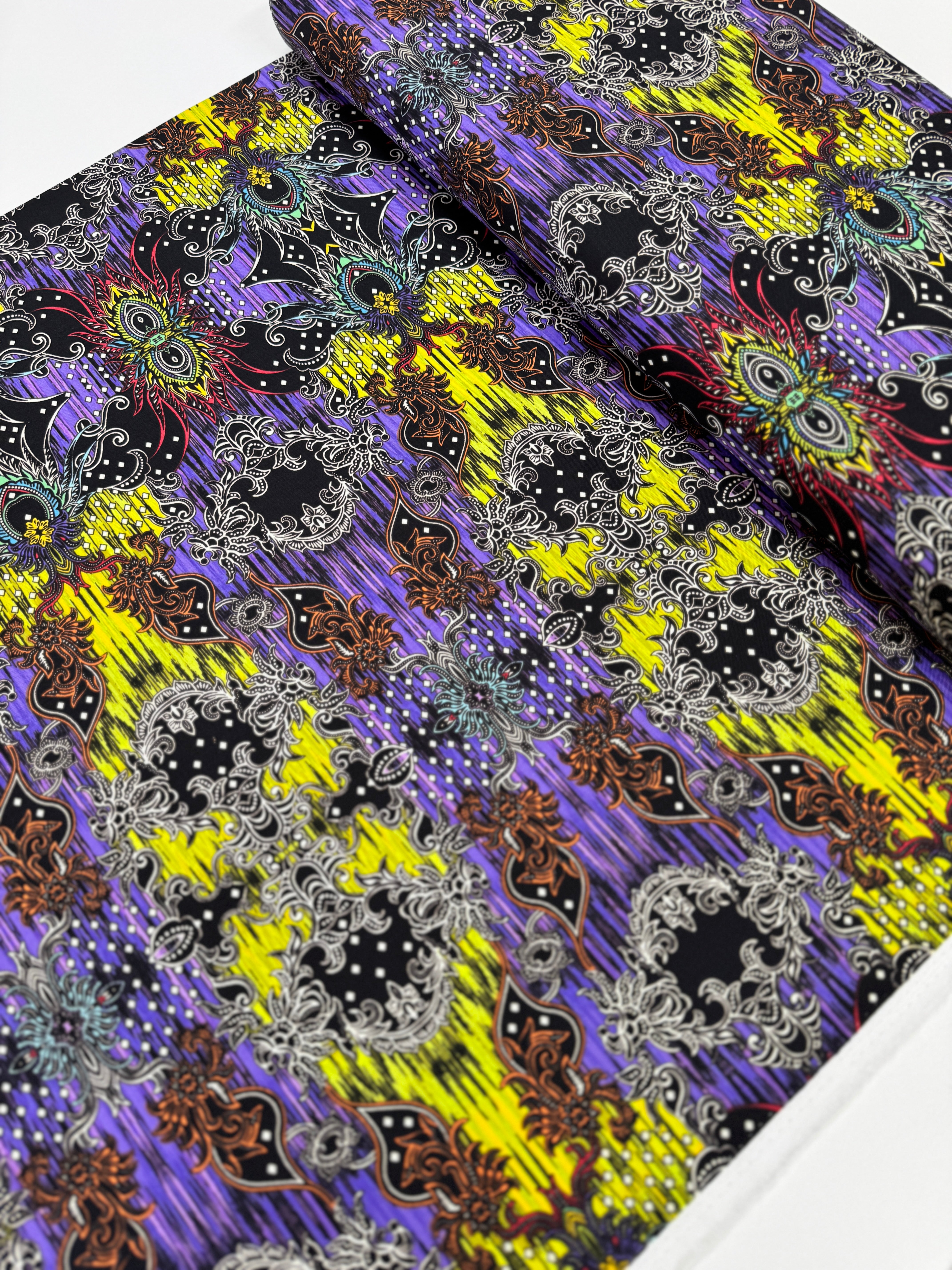 Close-up of Where in the World – Bali Green/Multi fabric by Paula Nadelstern for Benartex, digitally printed with intricate medallions.