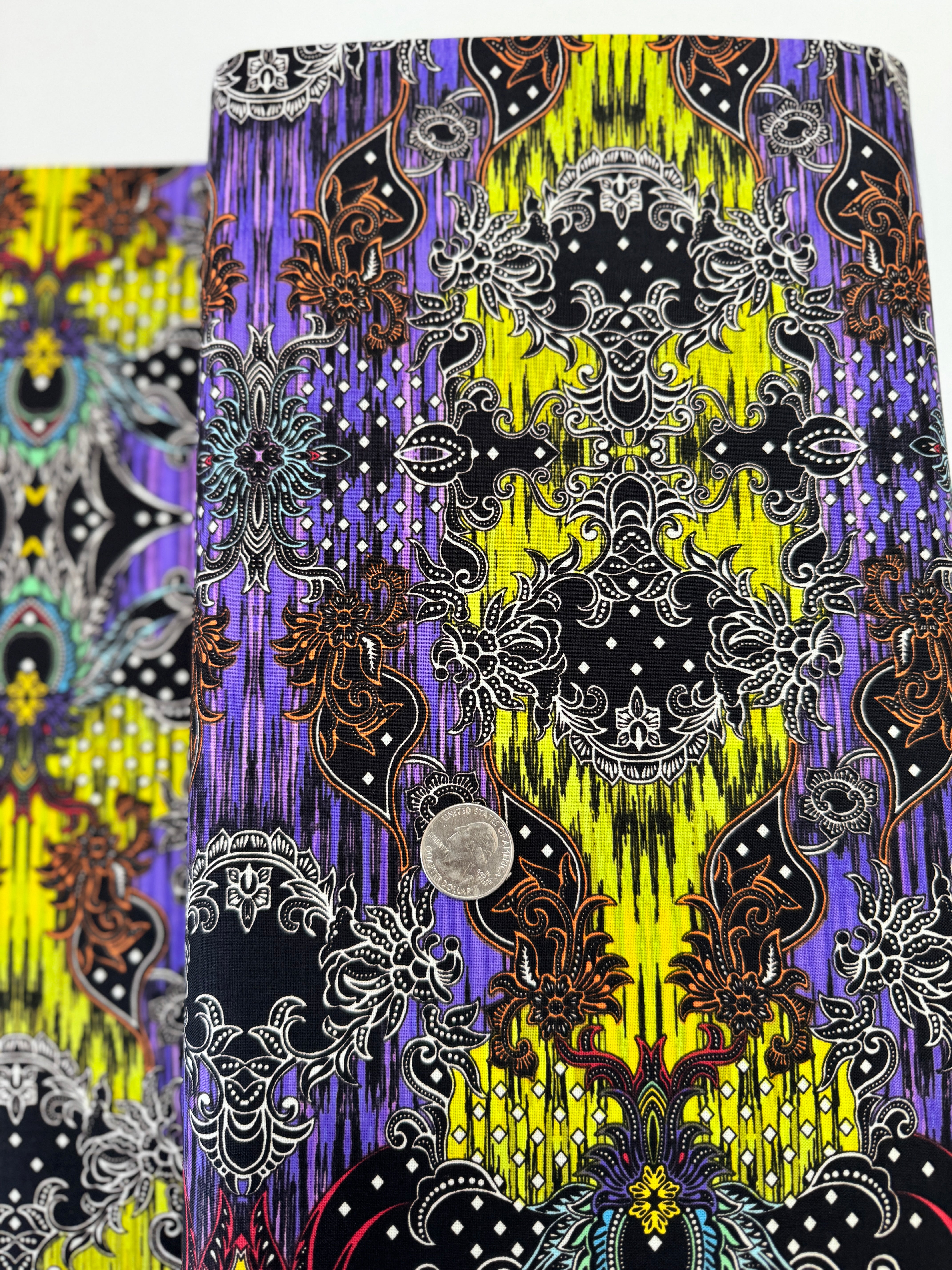 Close-up of Where in the World – Bali Green/Multi fabric by Paula Nadelstern for Benartex, digitally printed with intricate medallions.