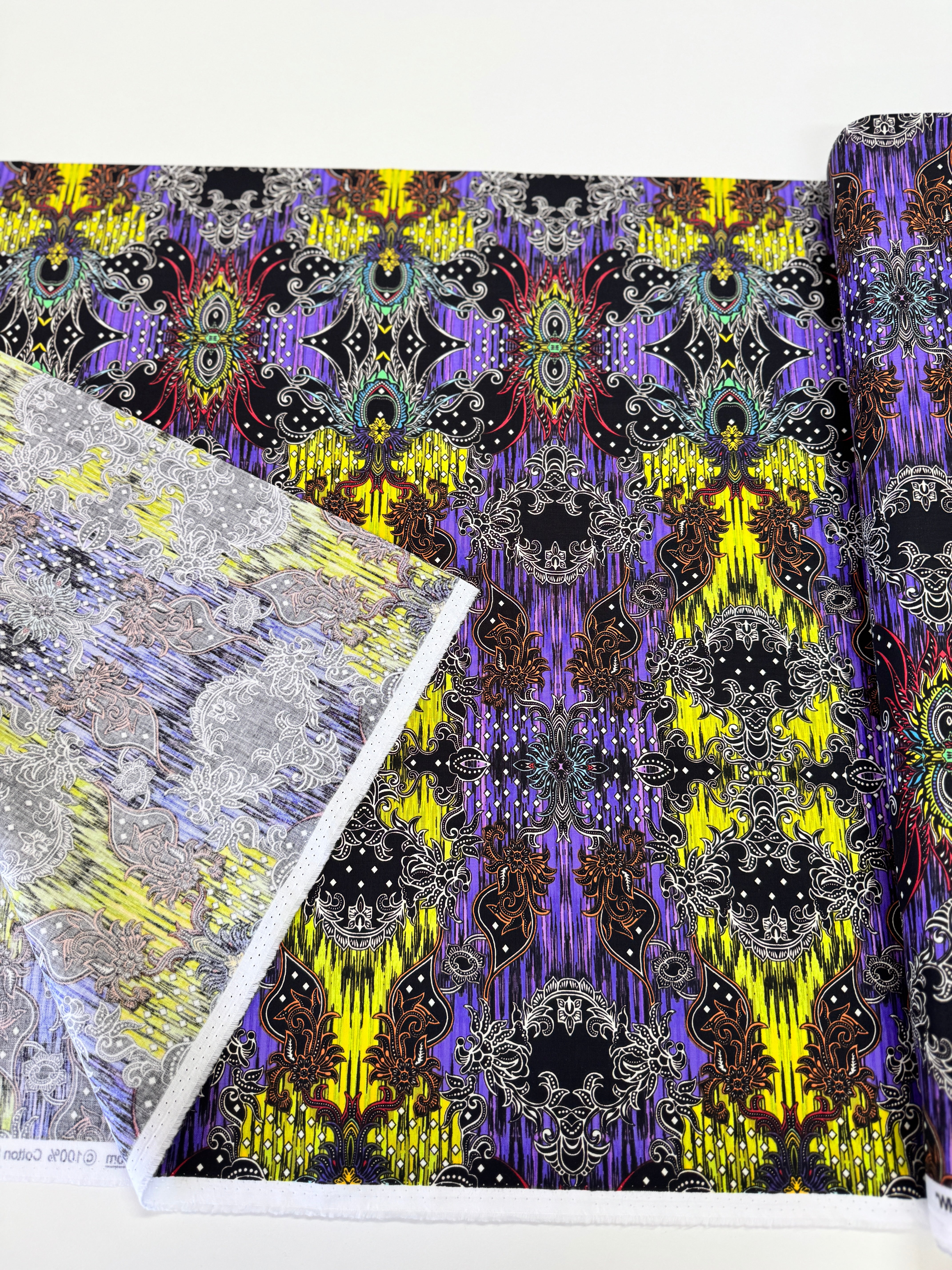 Close-up of Where in the World – Bali Green/Multi fabric by Paula Nadelstern for Benartex, digitally printed with intricate medallions.