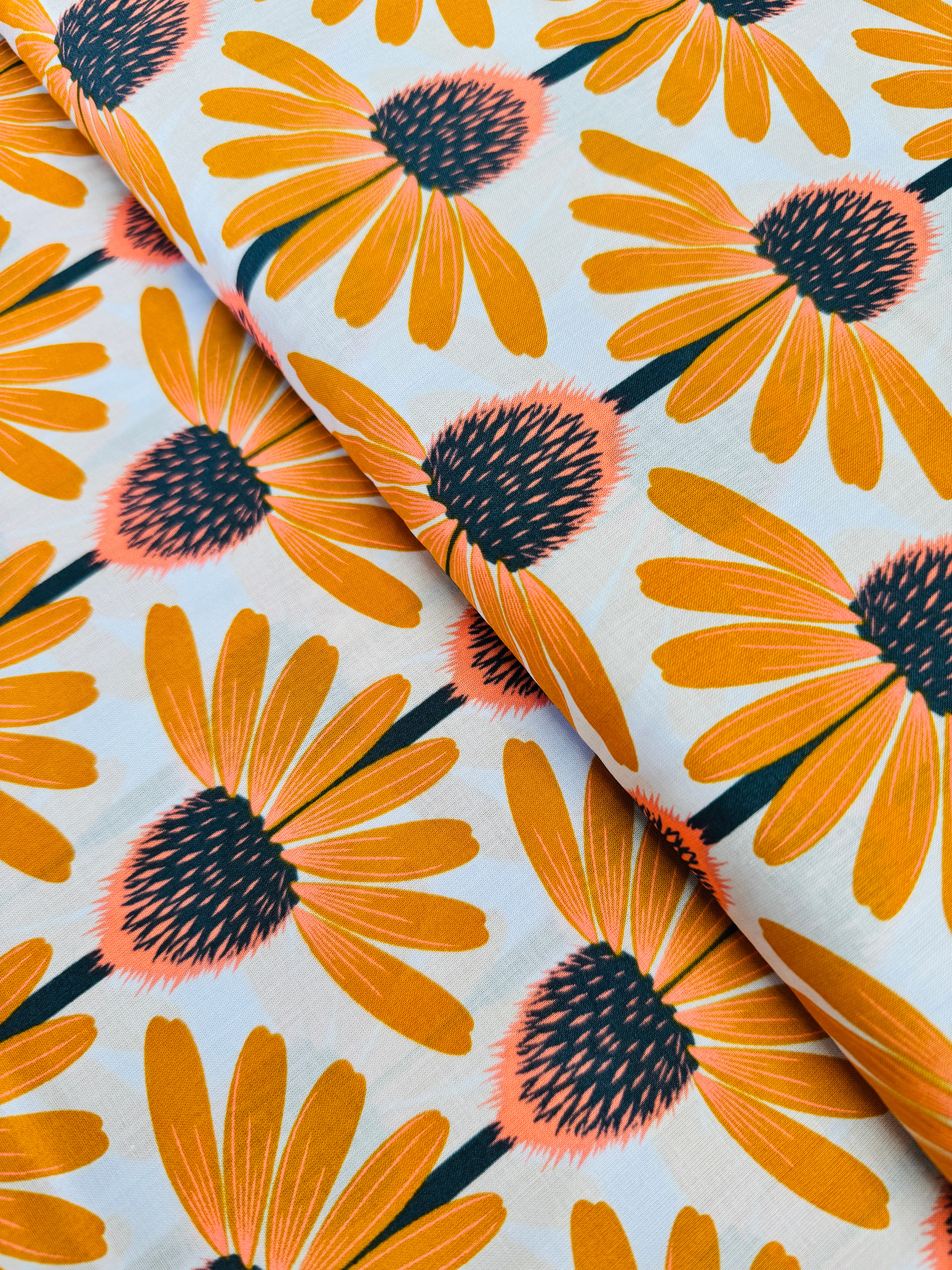 Love Always AM – Echinacea Morning Cotton Lawn by Anna Maria Horner featuring large yellow and coral echinacea flowers on a sky blue background.