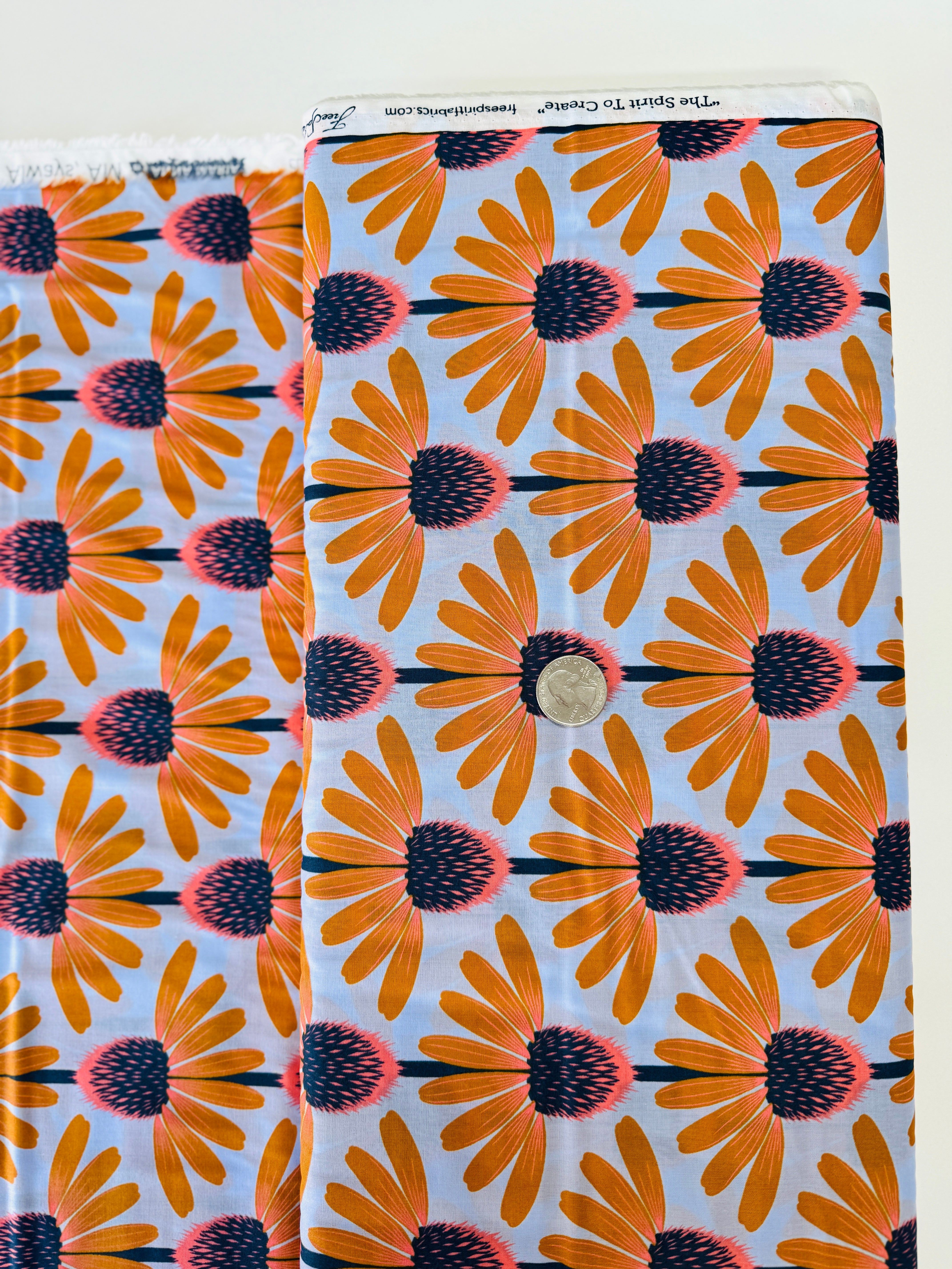 Love Always AM – Echinacea Morning Cotton Lawn by Anna Maria Horner featuring large yellow and coral echinacea flowers on a sky blue background.