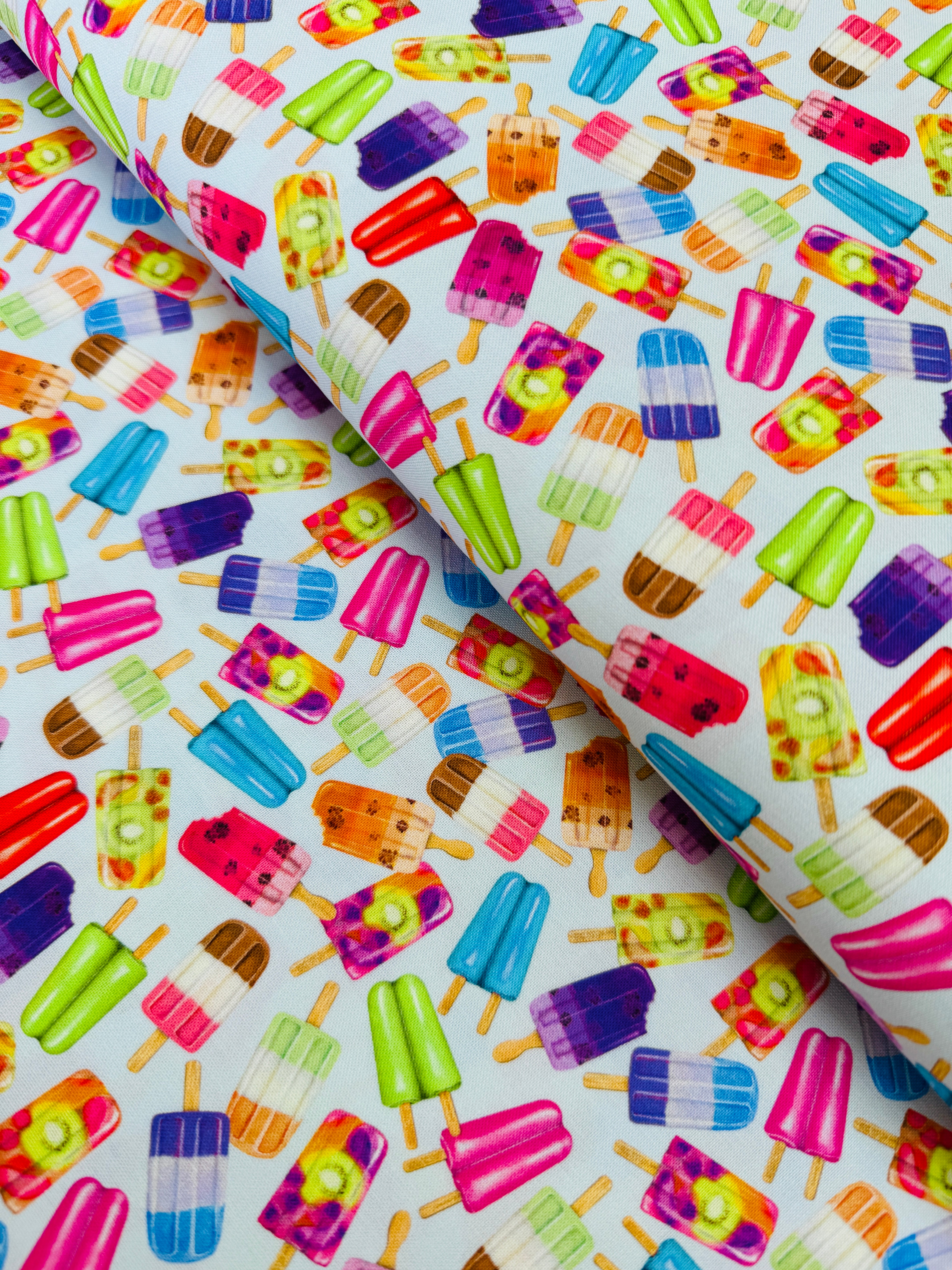 Sweet Tooth Popsicles on Blue fabric by Mary Lake Thompson for Robert Kaufman – colorful 100% cotton quilting fabric.