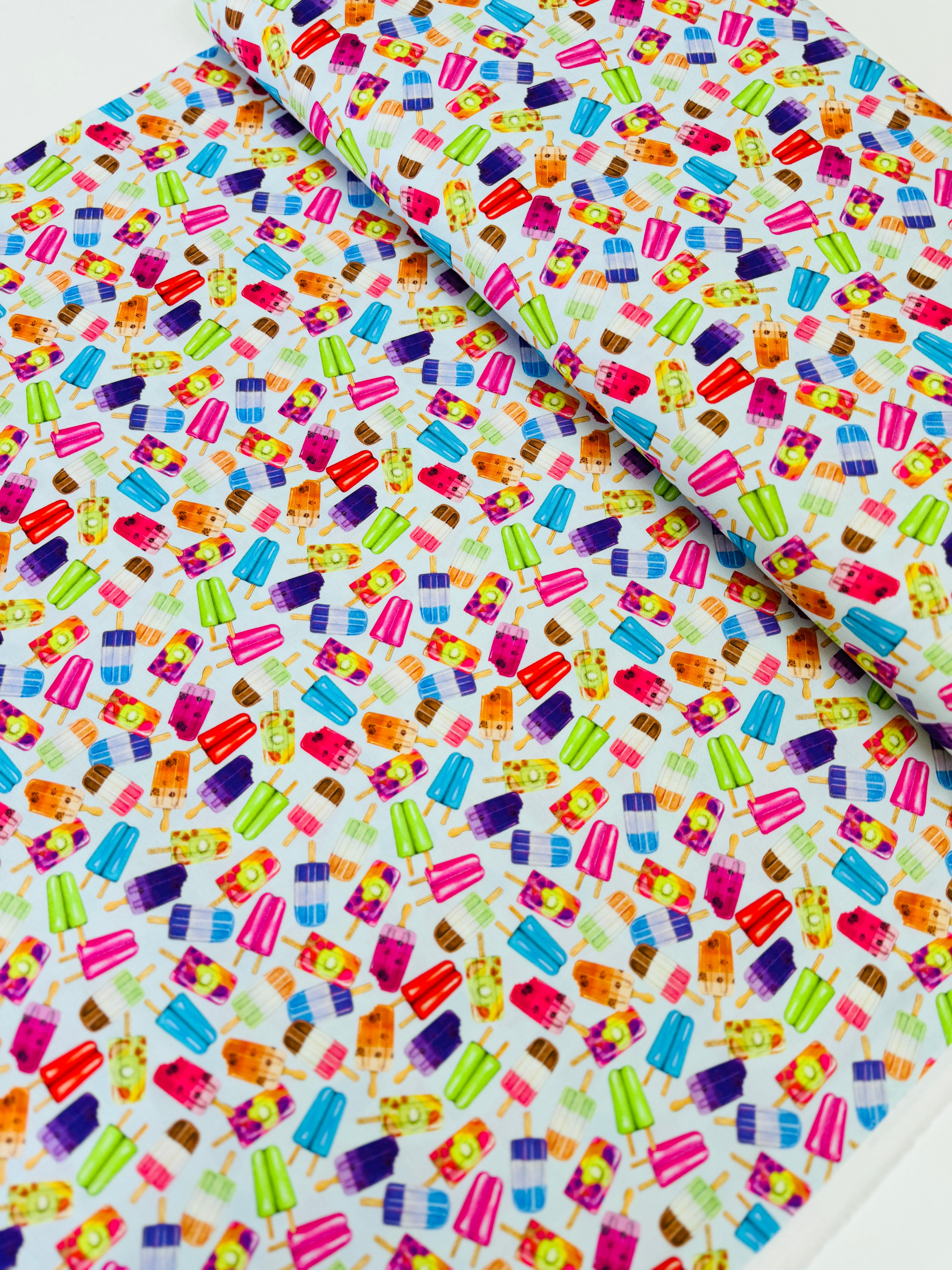 Sweet Tooth Popsicles on Blue fabric by Mary Lake Thompson for Robert Kaufman – colorful 100% cotton quilting fabric.