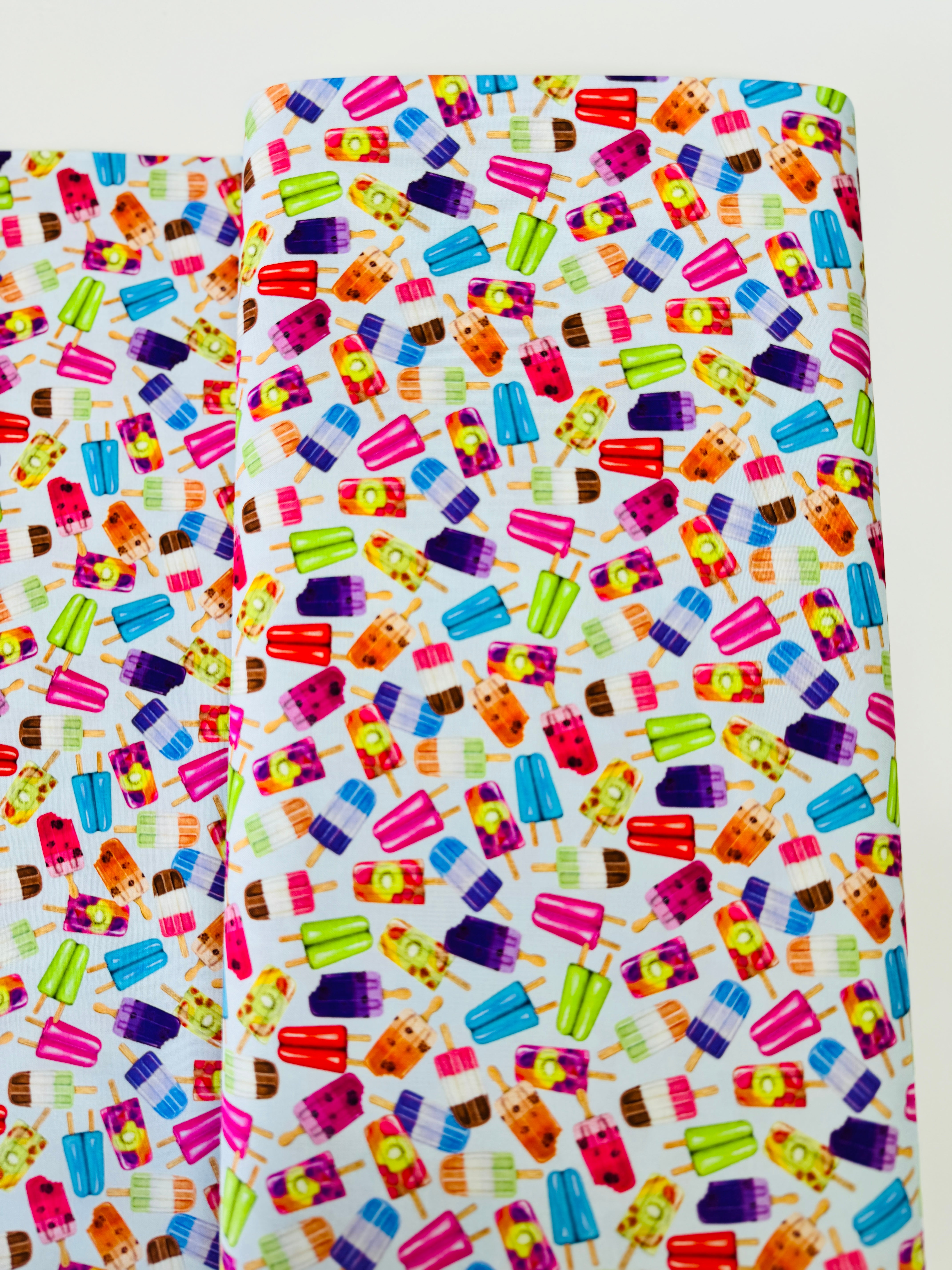 Sweet Tooth Popsicles on Blue fabric by Mary Lake Thompson for Robert Kaufman – colorful 100% cotton quilting fabric.