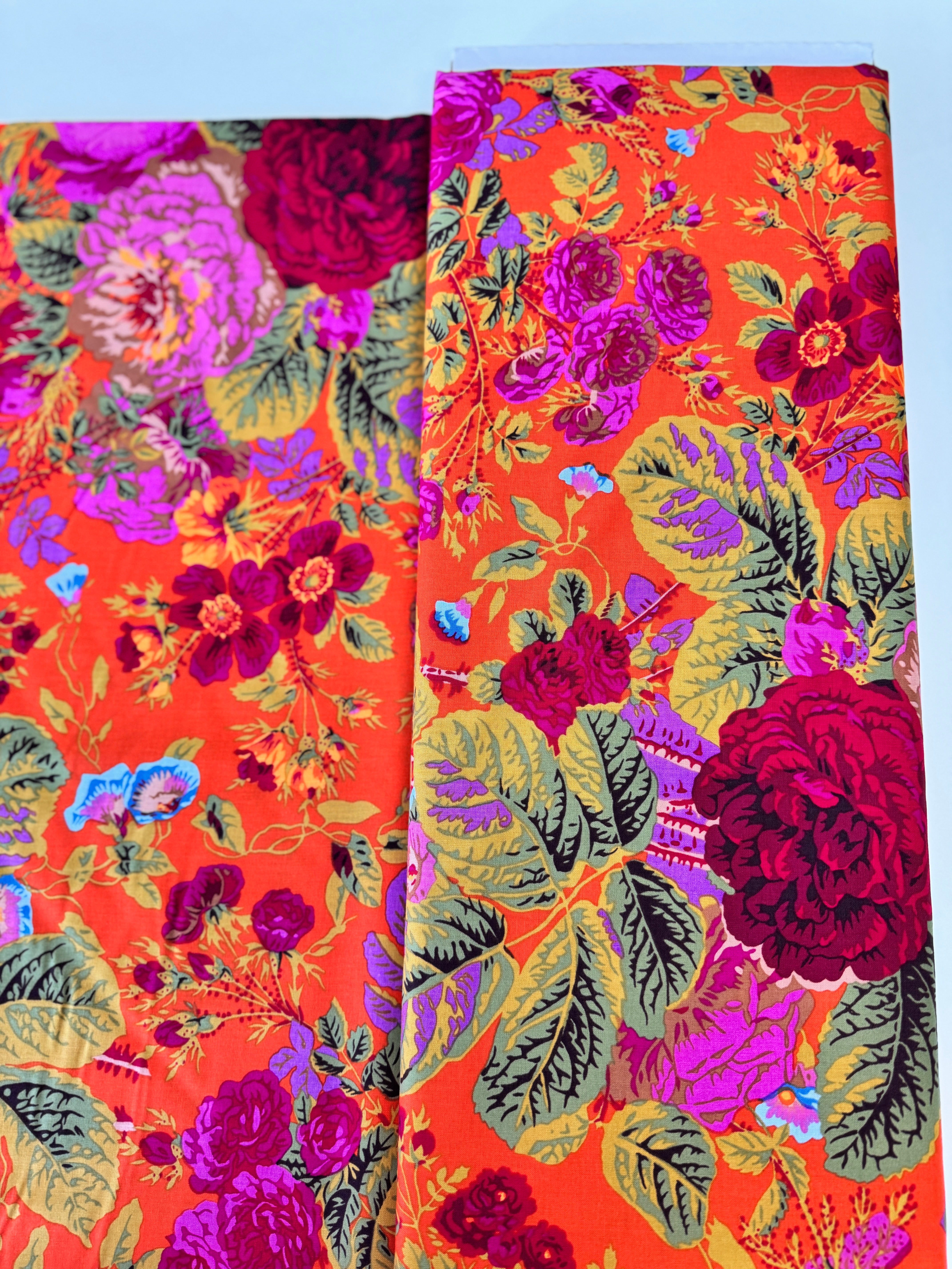 Kaffe Fassett Collective Gradi Floral Tomato fabric by Philip Jacobs for Free Spirit Fabrics featuring large bold floral blooms in pink and purple on a red background.
