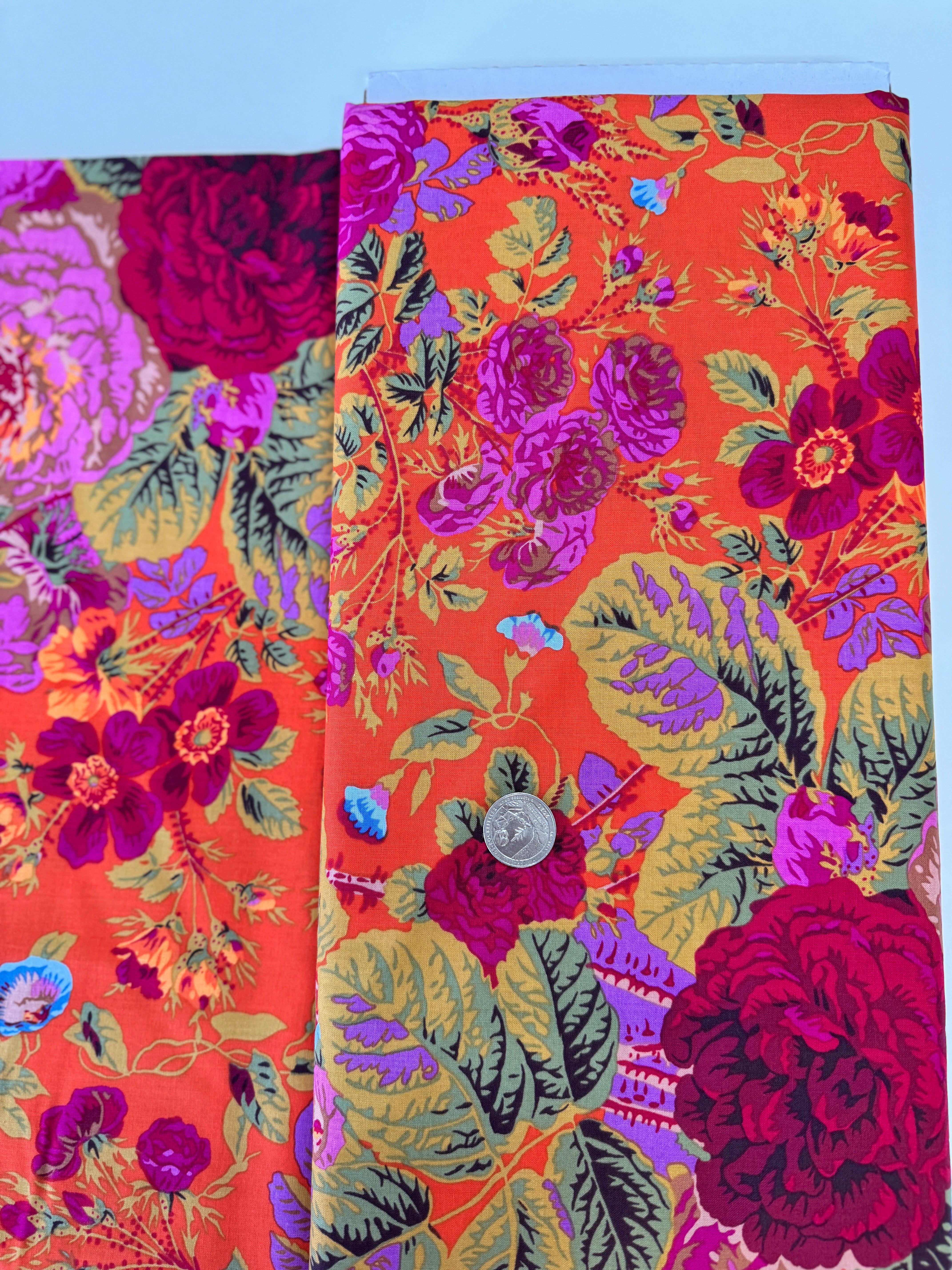 Kaffe Fassett Collective Gradi Floral Tomato fabric by Philip Jacobs for Free Spirit Fabrics featuring large bold floral blooms in pink and purple on a red background.