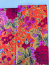 Kaffe Fassett Collective Gradi Floral Tomato fabric by Philip Jacobs for Free Spirit Fabrics featuring large bold floral blooms in pink and purple on a red background.