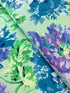 Kaffe Fassett Collective Garden Party Celadon fabric by Philip Jacobs for Free Spirit Fabrics featuring large blue and purple floral blooms with green leaves on a celadon background.