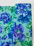Kaffe Fassett Collective Garden Party Celadon fabric by Philip Jacobs for Free Spirit Fabrics featuring large blue and purple floral blooms with green leaves on a celadon background.