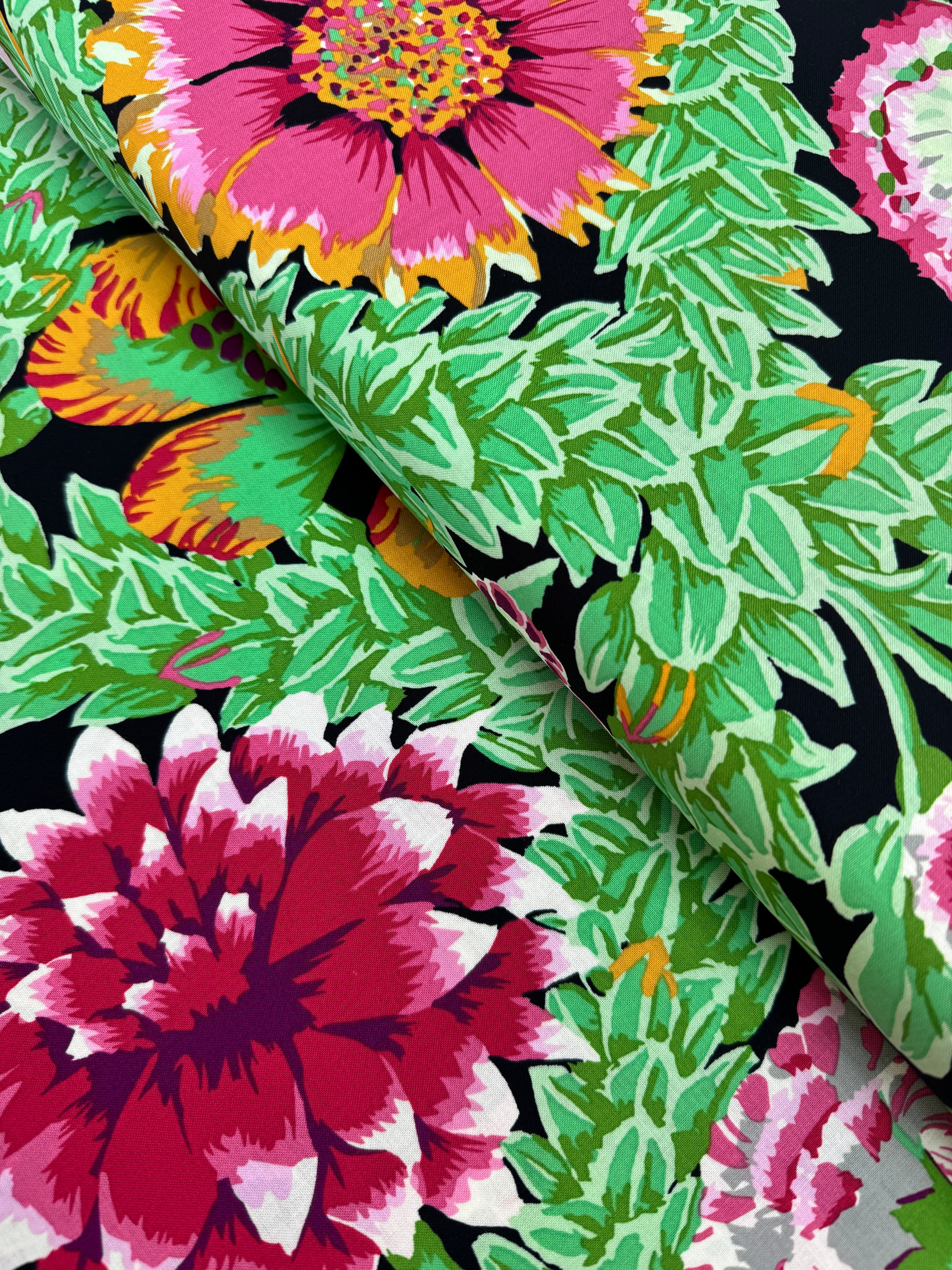 Kaffe Fassett Collective Vintage Flower Lattice Jewel fabric by Philip Jacobs for Free Spirit Fabrics featuring bold pink and green floral pattern on black background.