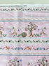 A pastel pink cotton fabric featuring rows of playful deer, white bunnies, trees, and flowers in a stripe pattern - Storybook Forest - Bunnies & Deer Stripe by Timeless Treasures.