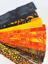 Assorted Halloween batik scrap strip bundle in orange, black, and gold tones, 2-inch strips by Island Batik.