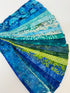 Assorted ocean-themed batik scrap strip bundle in blue, teal, and green 2-inch strips by Island Batik.