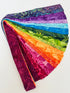 Assorted rainbow batik fabric strips fanned out, featuring 21 colorful 2-inch strips by Kathy Engle for Island Batik.