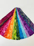 Assorted rainbow batik fabric strips fanned out, featuring 21 colorful 2-inch strips by Kathy Engle for Island Batik.