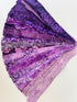 Assorted purple batik fabric strips fanned out, featuring 21 lavender to deep violet 2-inch strips by Kathy Engle for Island Batik.