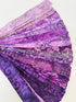 Assorted purple batik fabric strips fanned out, featuring 21 lavender to deep violet 2-inch strips by Kathy Engle for Island Batik.