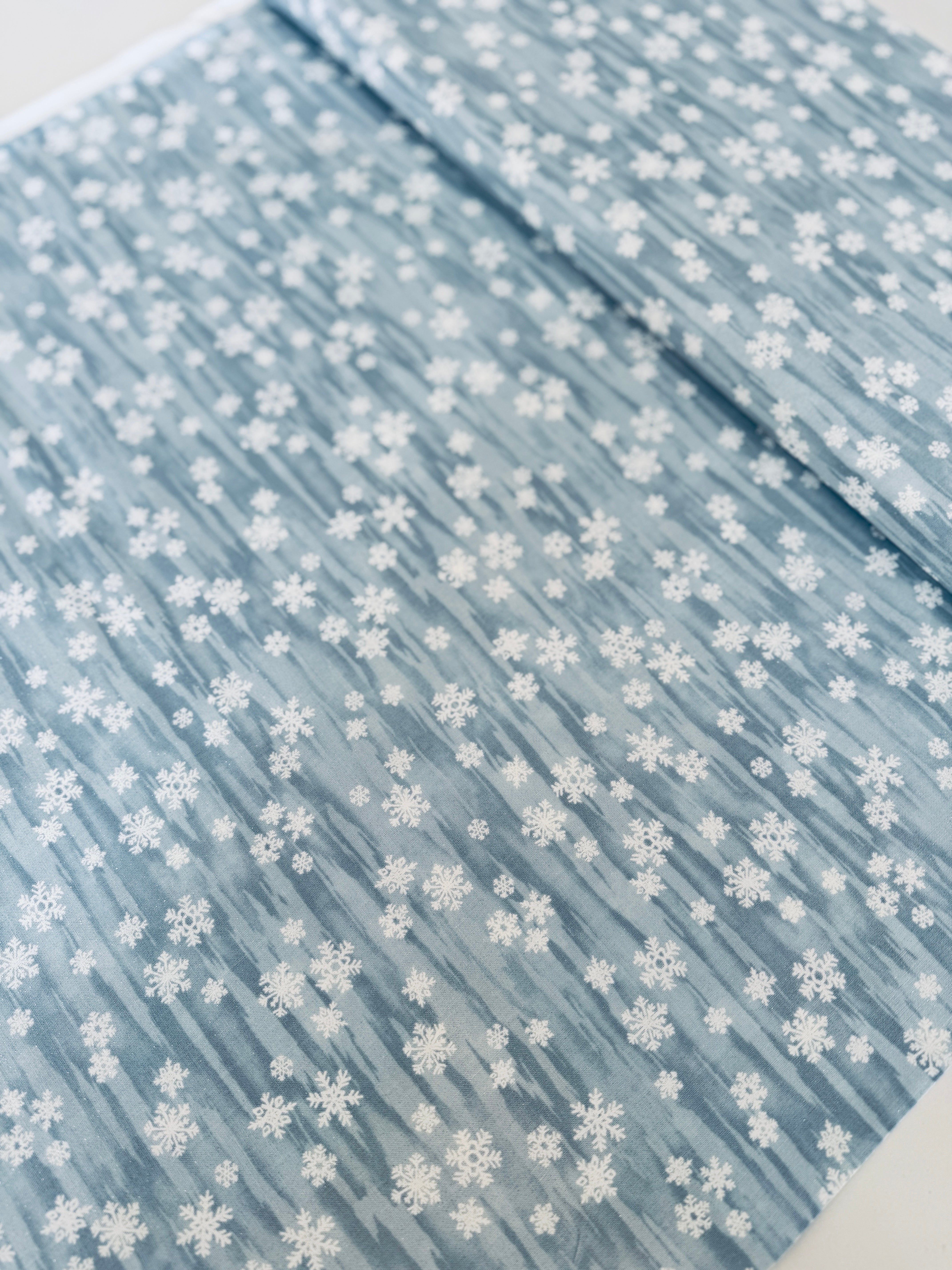 Forest Frost metallic snowflakes fabric in frosty blue by Moda Fabrics