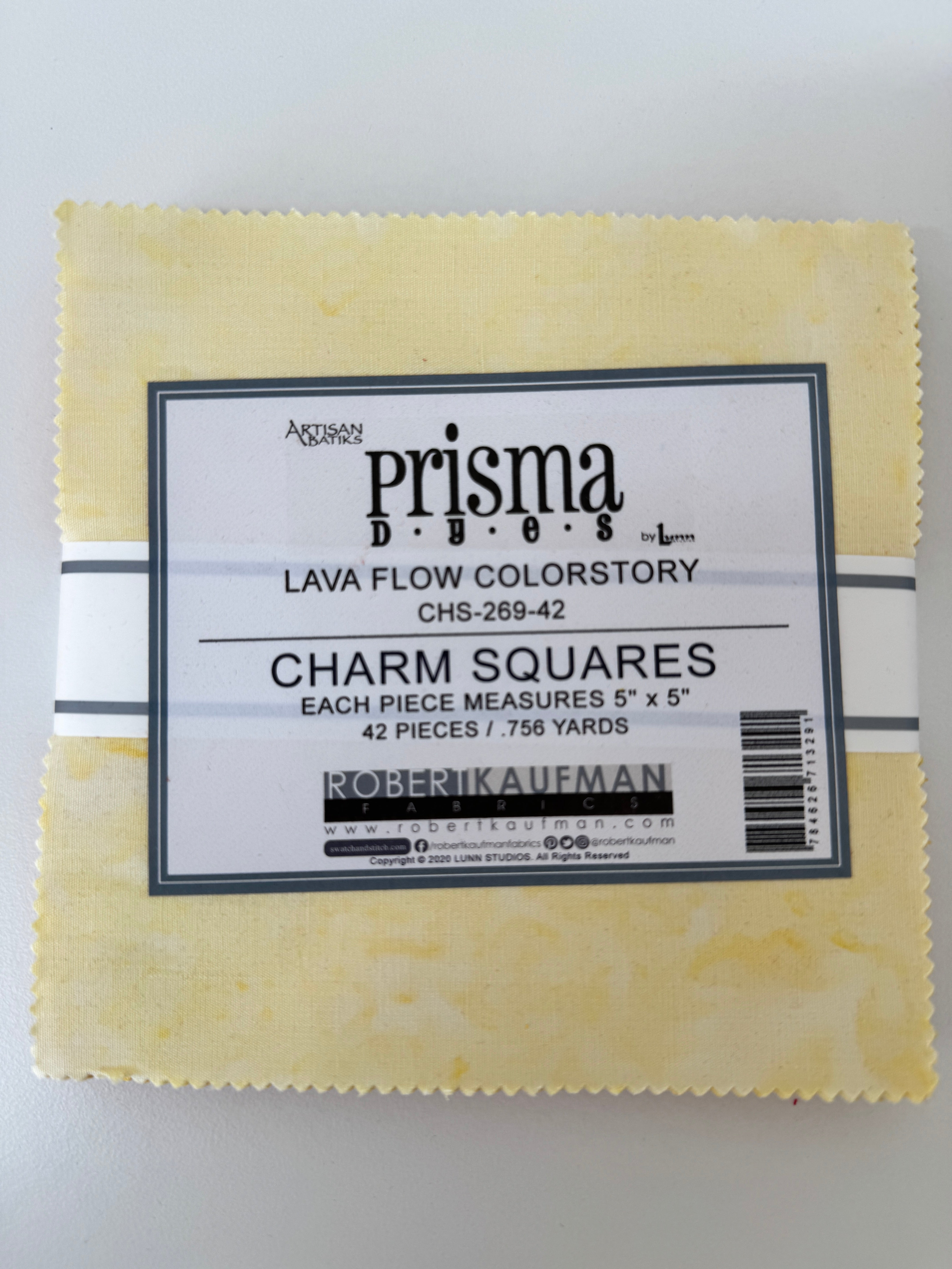 Prisma Dyes Lava Flow charm pack by Robert Kaufman showing 5" batik squares in soft yellow tonal colors.