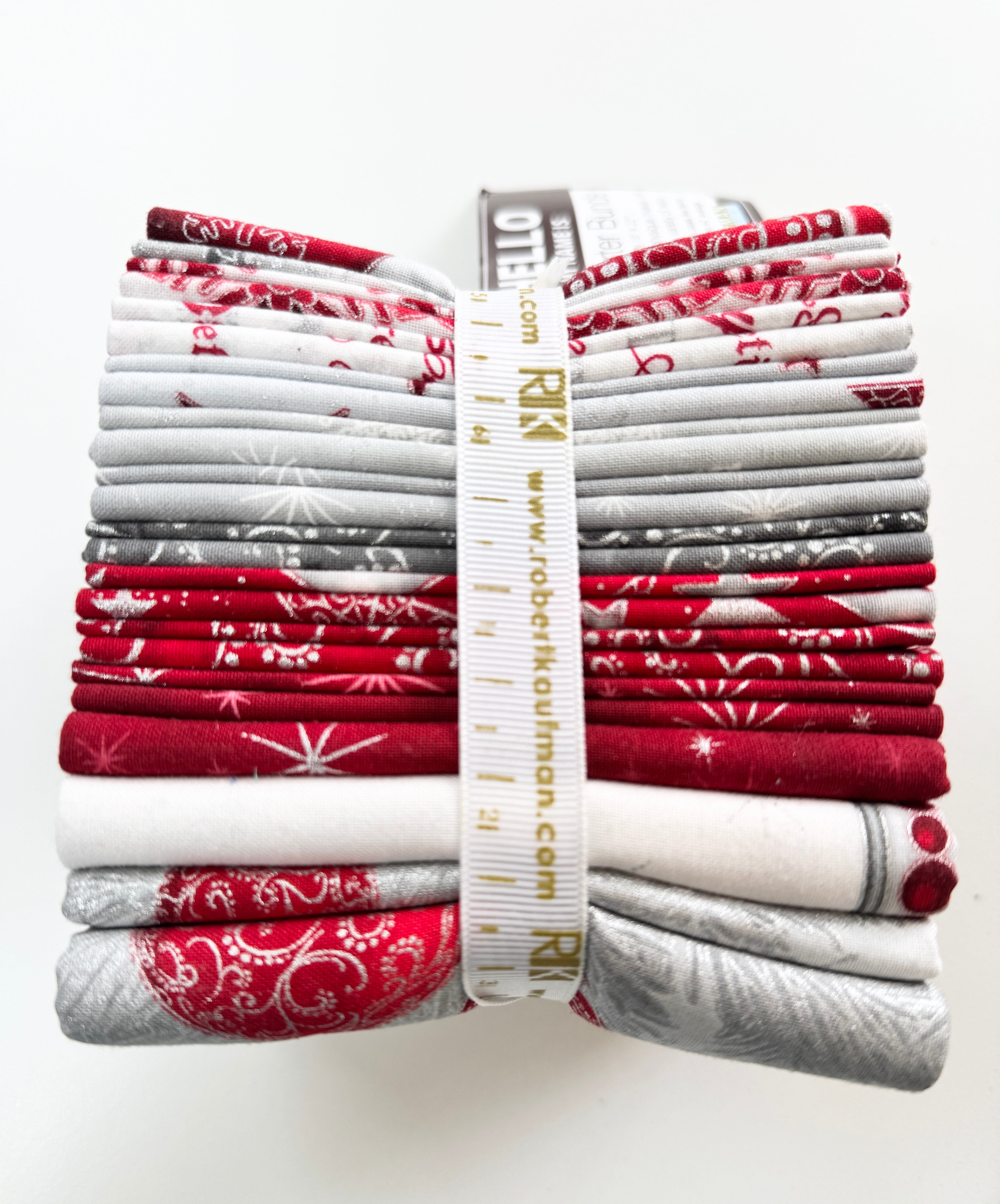 Winter’s Grandeur winter colorstory fat quarter bundle with red, gray, and white holiday quilting cotton fabrics